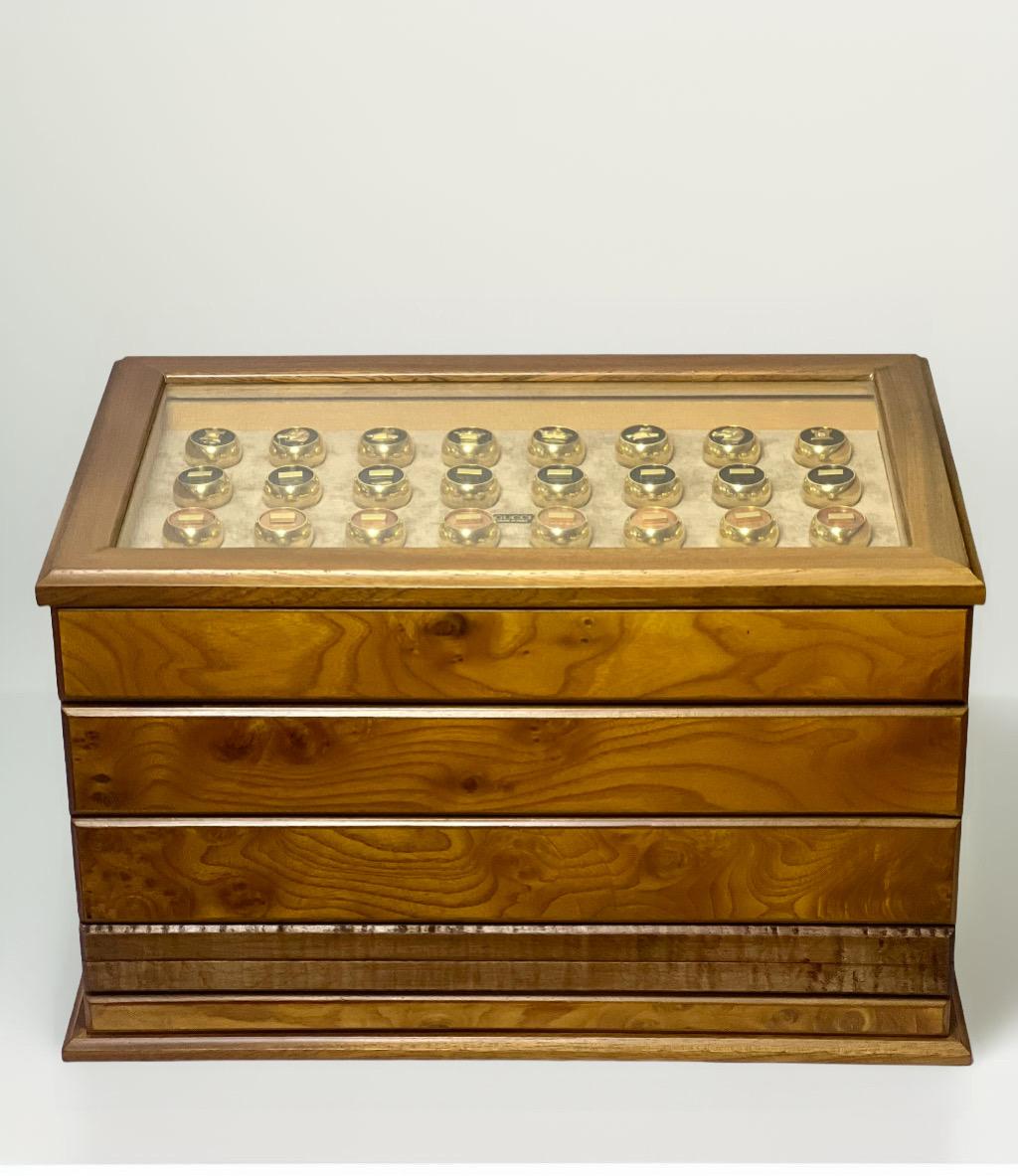 Rare vintage Gucci classic games chest crafted of burled maple with a glass top, made in Italy, mid to late 20th century. A handsome chest offering a tailored presentation of a fine games collection consisting of three plushly lined drawers and a