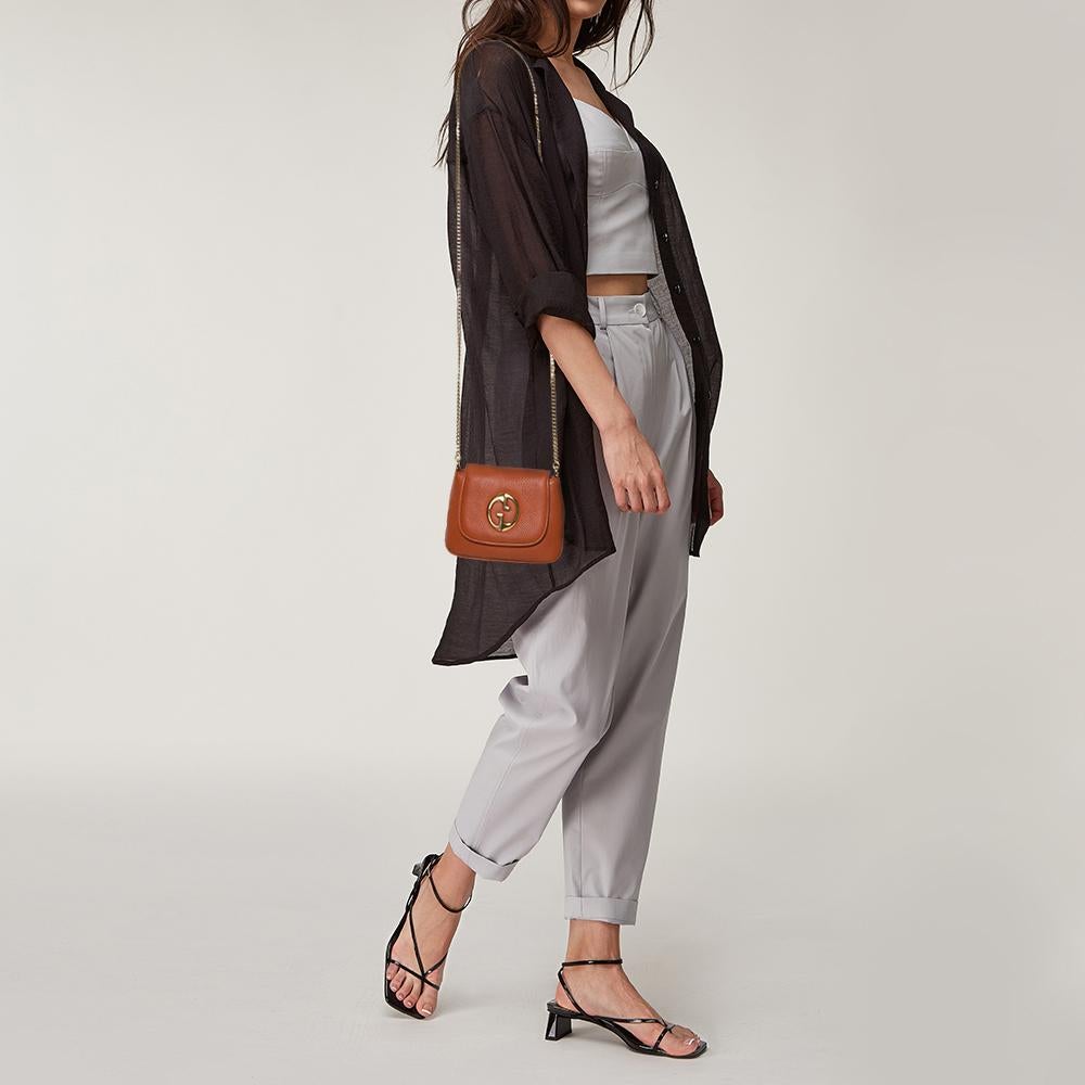 To make a brilliant fashion statement, this bag by Gucci is just what you need! High in style and craftsmanship, this 1973 shoulder bag has been crafted from burnt orange leather and comes with a flap that reveals a suede interior for housing the
