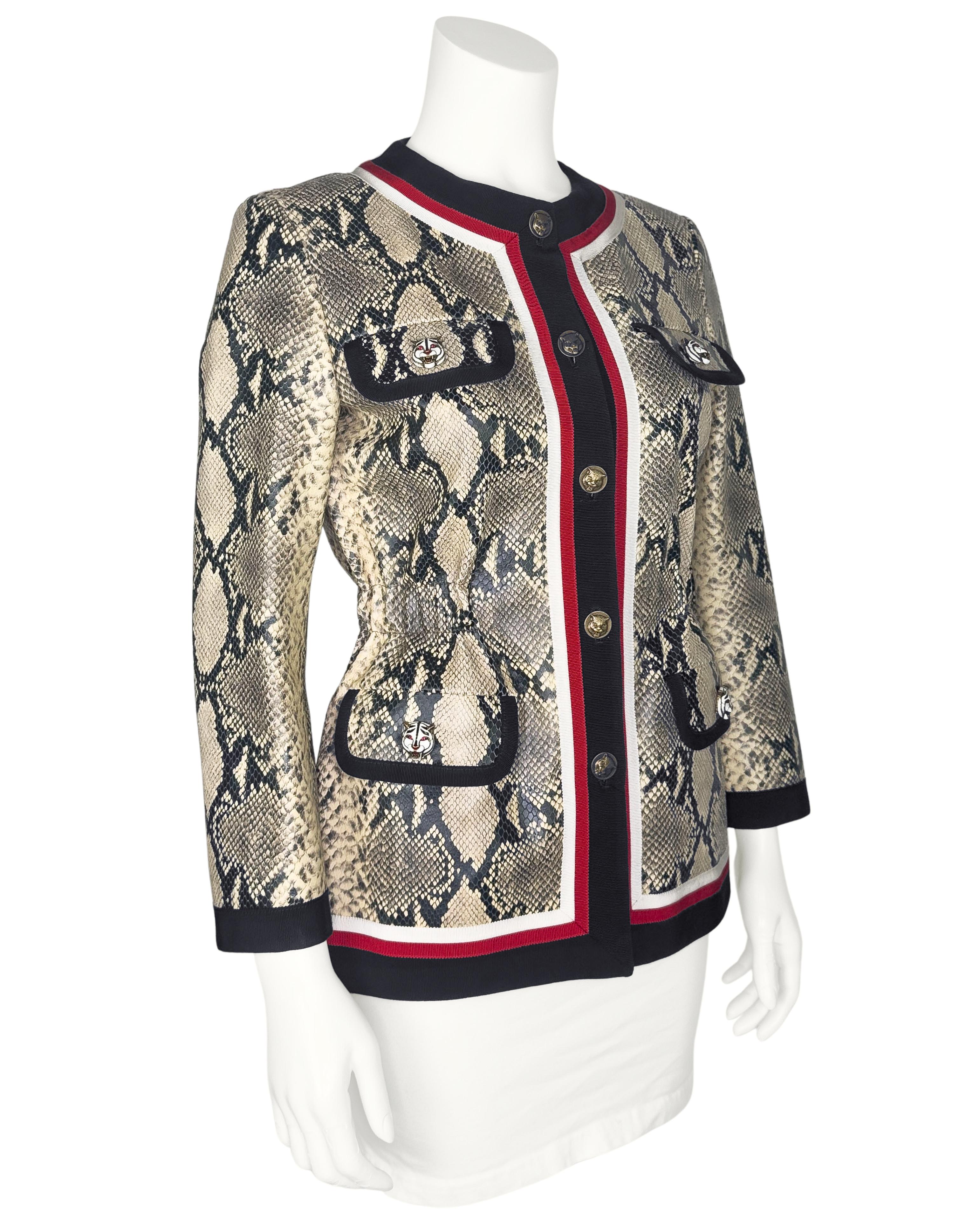 Gucci jacket designed by Alessandro Michele from approximately 2018. Beige and black leather treated and printed to look and feel like snakeskin. Stunning black, red and white grosgrain trim. Four functional flap pockets with enamel white tiger head