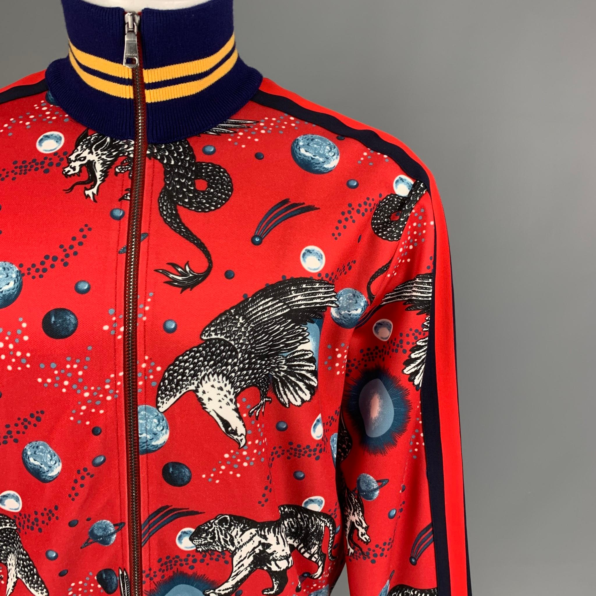 GUCCI by Alessandro Michele FW 17 jacket comes in a red 'space animal' graphic print featuring a high collar, striped ribbed hem, slit pockets, and a full zip up closure. Made in Italy. 

Excellent Pre-Owned Condition.
Marked: