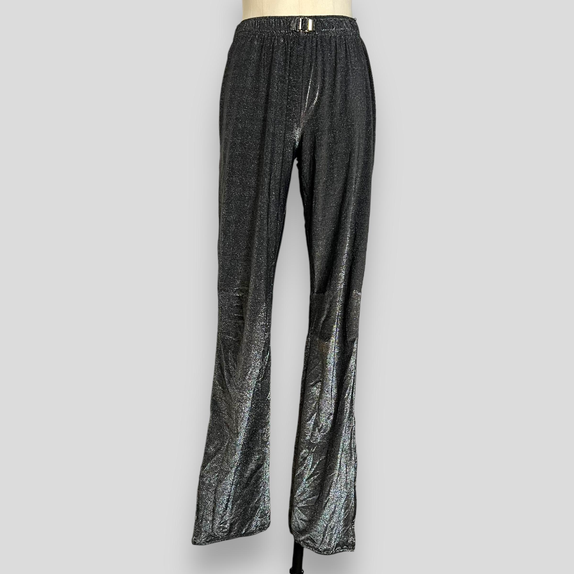 We offer rare vintage GUCCI black silver lurex metallic fluid track pants from Tom Ford's iconic SS 2000 collection. These track pants are crafted from shiny black and silver lurex viscose fabric, presenting a luxurious and chic aesthetic. The
