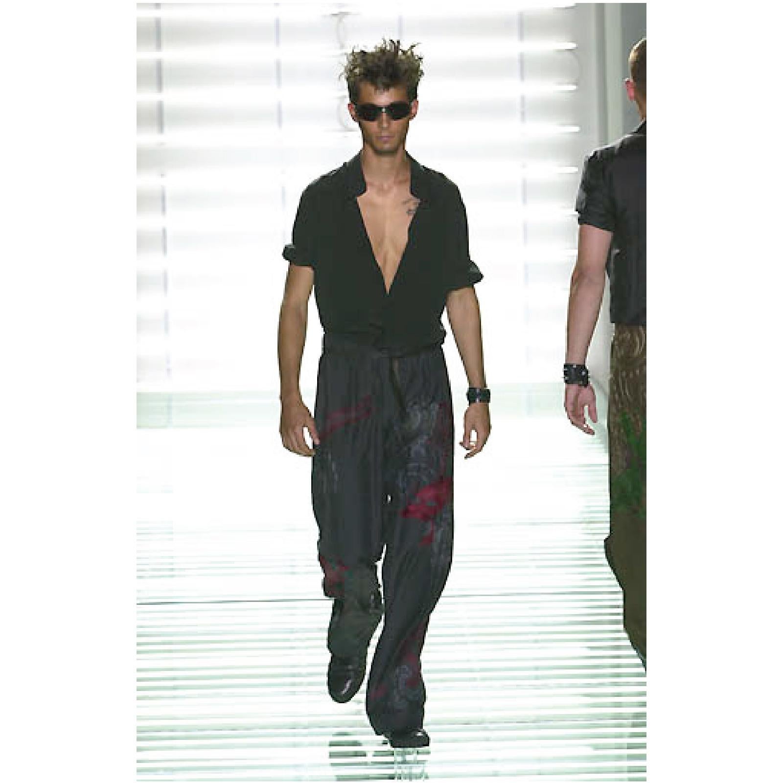 GUCCI by TOM FORD Spring Summer 2001 Collection karate style pants come in black silk with burgundy and gray dragon embroidery throughout, button fly, tied drawstring waistband, and quilted hem. Wear. Made in Italy.
 
Very Good Pre-Owned