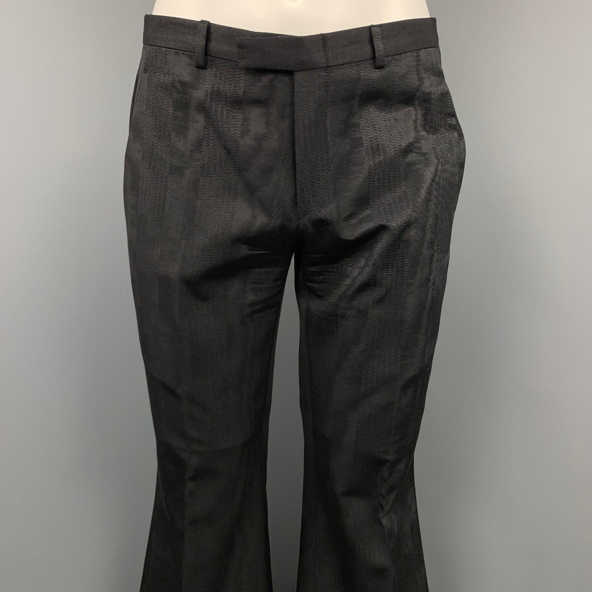 GUCCI by TOM FORD dress pants comes in a black jacquard material featuring a wide leg style, front tab, and a zip fly closure. Missing fabric tag.

Very Good Pre-Owned Condition.
Marked: No fabric tag.

Measurements:

Waist: 32 in.
Rise: 9