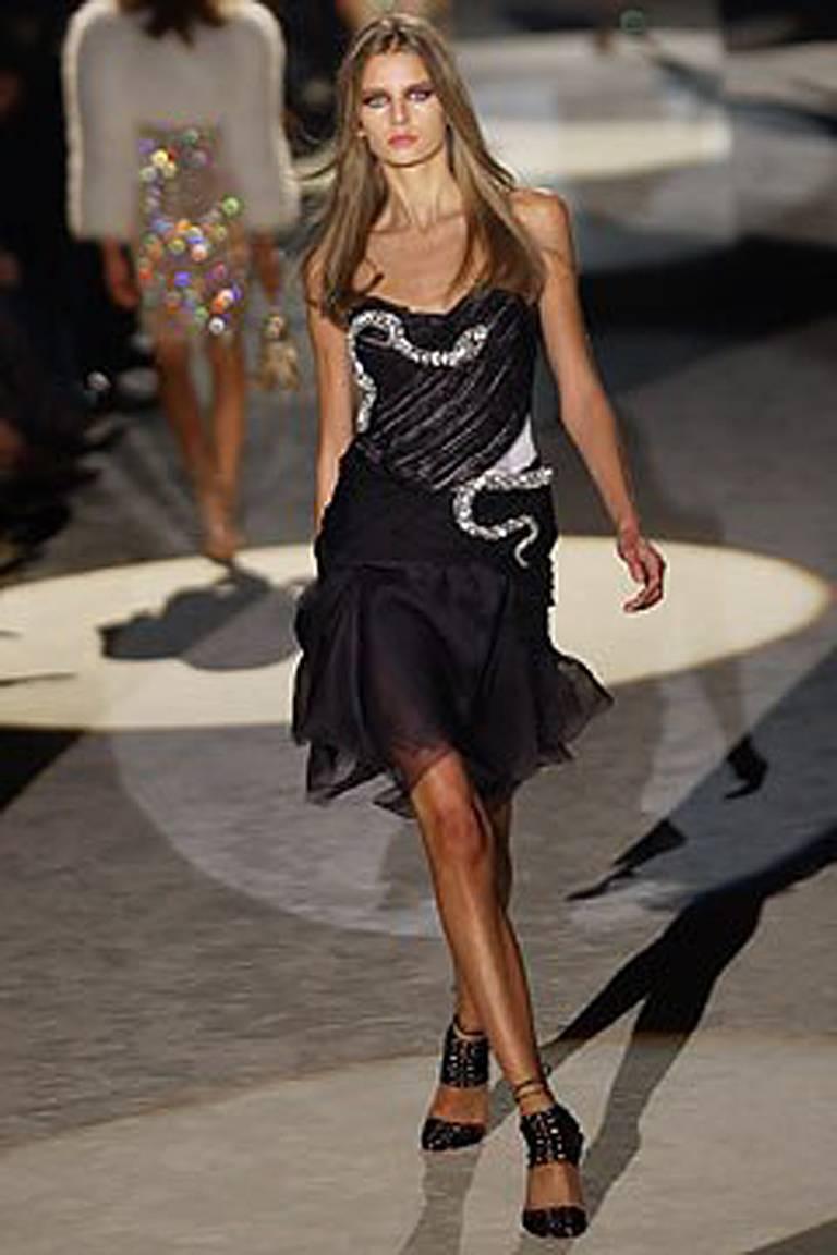 Gucci's 2004 Spring collection by Tom Ford featured eye catching evening dresses designed with glittery crystal  snake motifs wound around the torso of each dress and finished with raw cutting on edging of the wisps of black silk chiffon.   Body