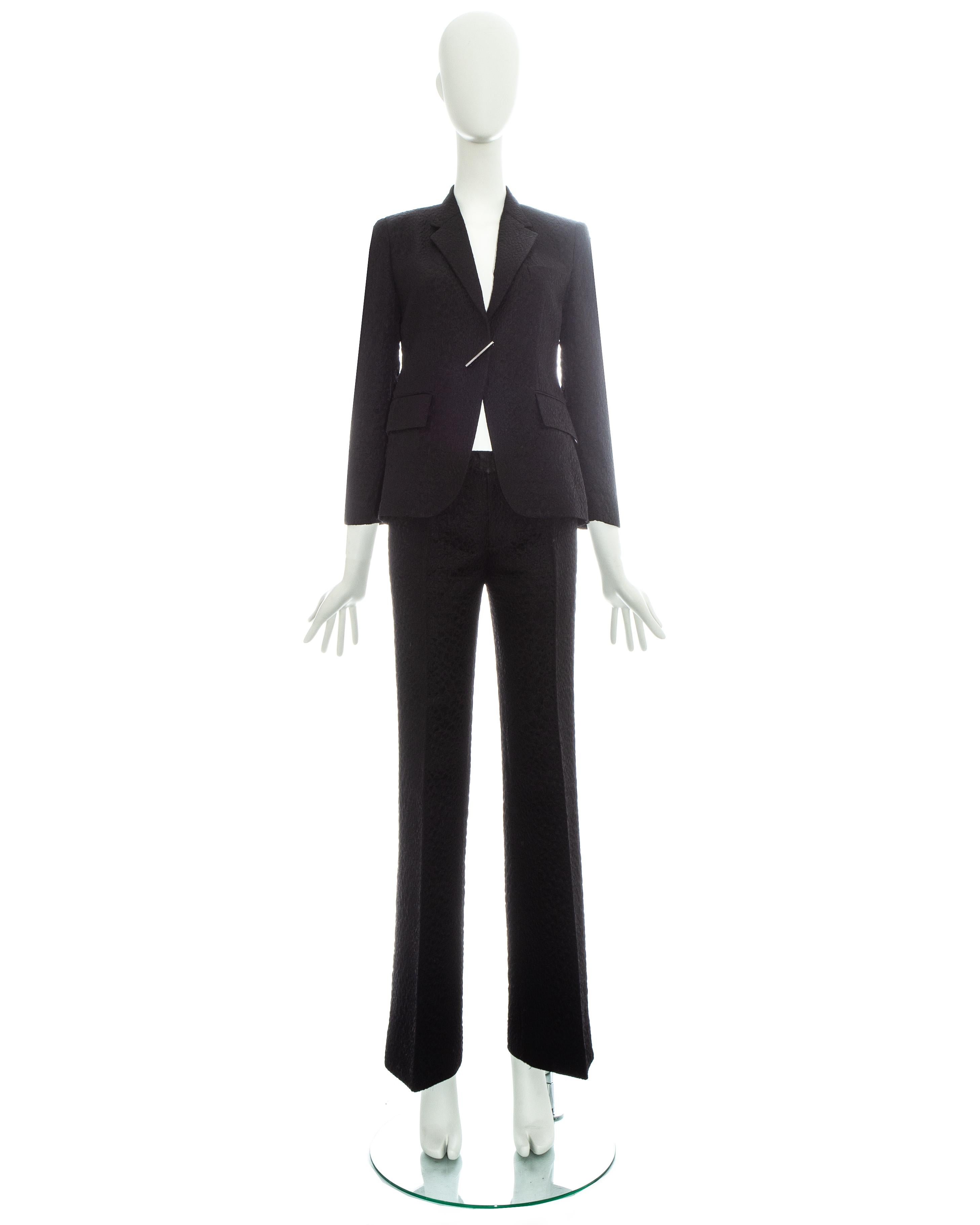Gucci by Tom Ford black croc embossed flared pant suit with silver diamanté clasp fastening.

Spring-Summer 2000