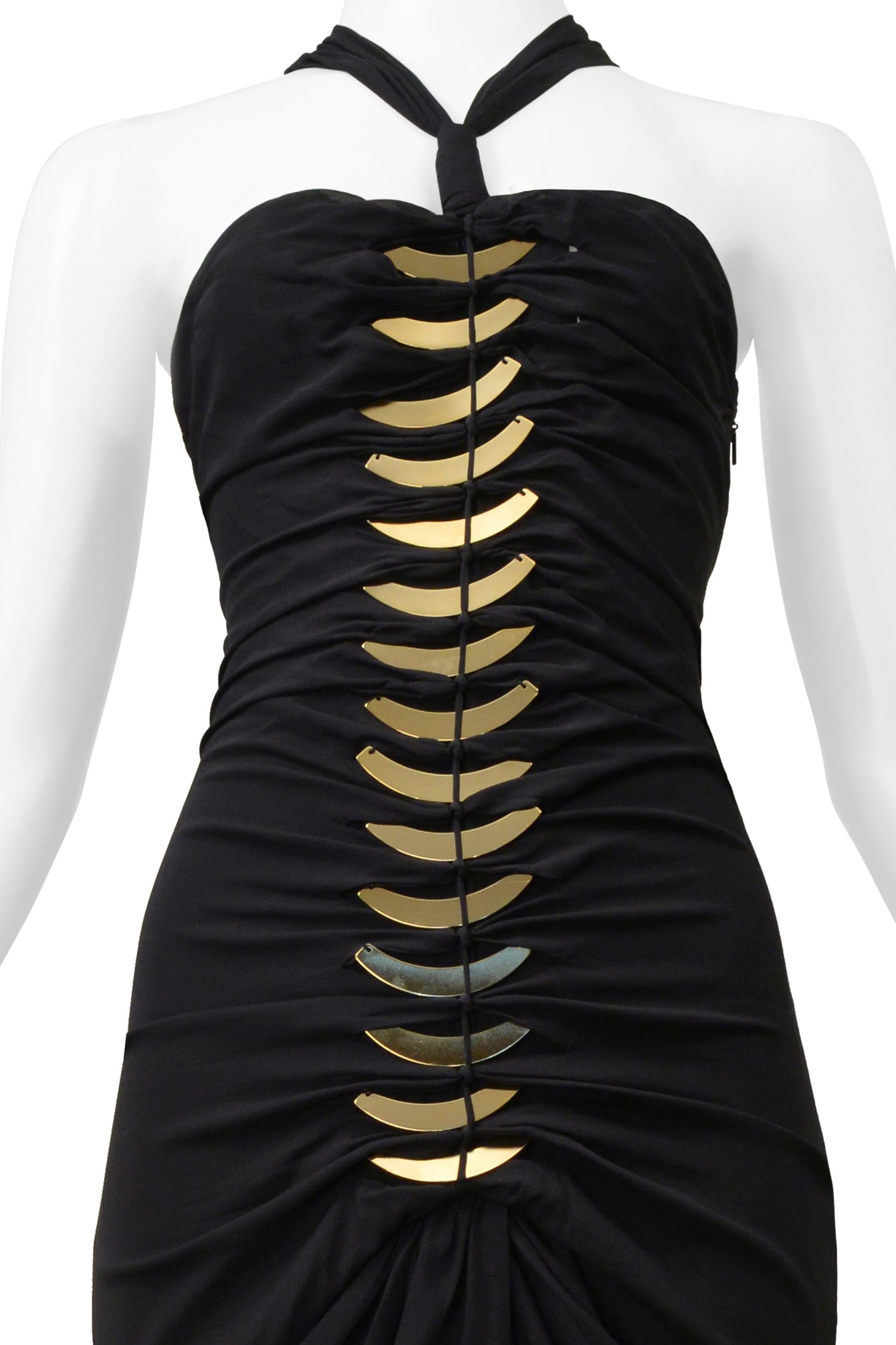 Resurrection Vintage is excited to offer a stunning black 2004 Tom Ford for Gucci dress featuring a strapless body with collar straps, center front and back cutouts, gold-tone fin hardware, side zipper, and gathered sides and back panel.
* Gucci
*