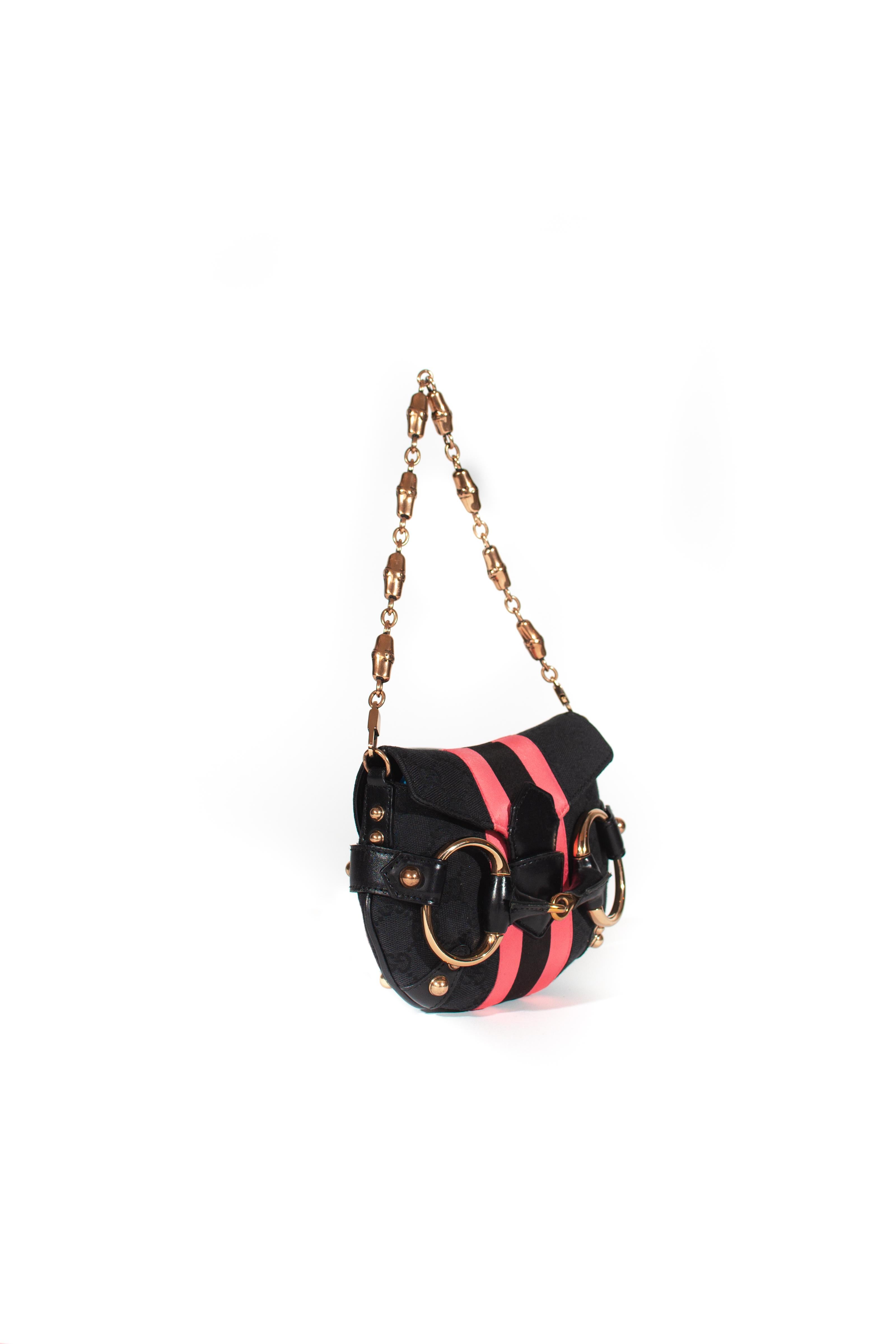 Presenting  Designed by Tom Ford during his tenure at the house of Gucci, this bag represents Tom's interpretation of many of Gucci's classic elements ('GG' canvas, horse bits, etc.). This mini evening convertible bag is constructed of black 'GG'