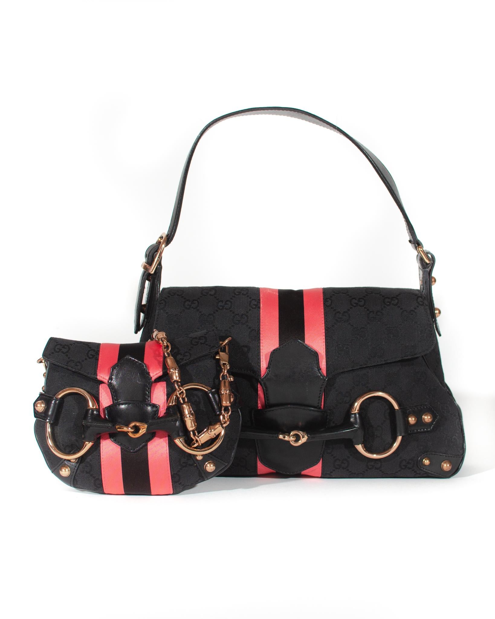 Designed by Tom Ford during his tenure at the house of Gucci, this bag represents Tom's interpretation of many of Gucci's classic elements ('GG' canvas, horse bits, etc.). This shoulder bag is constructed of black 'GG' canvas with a large black and