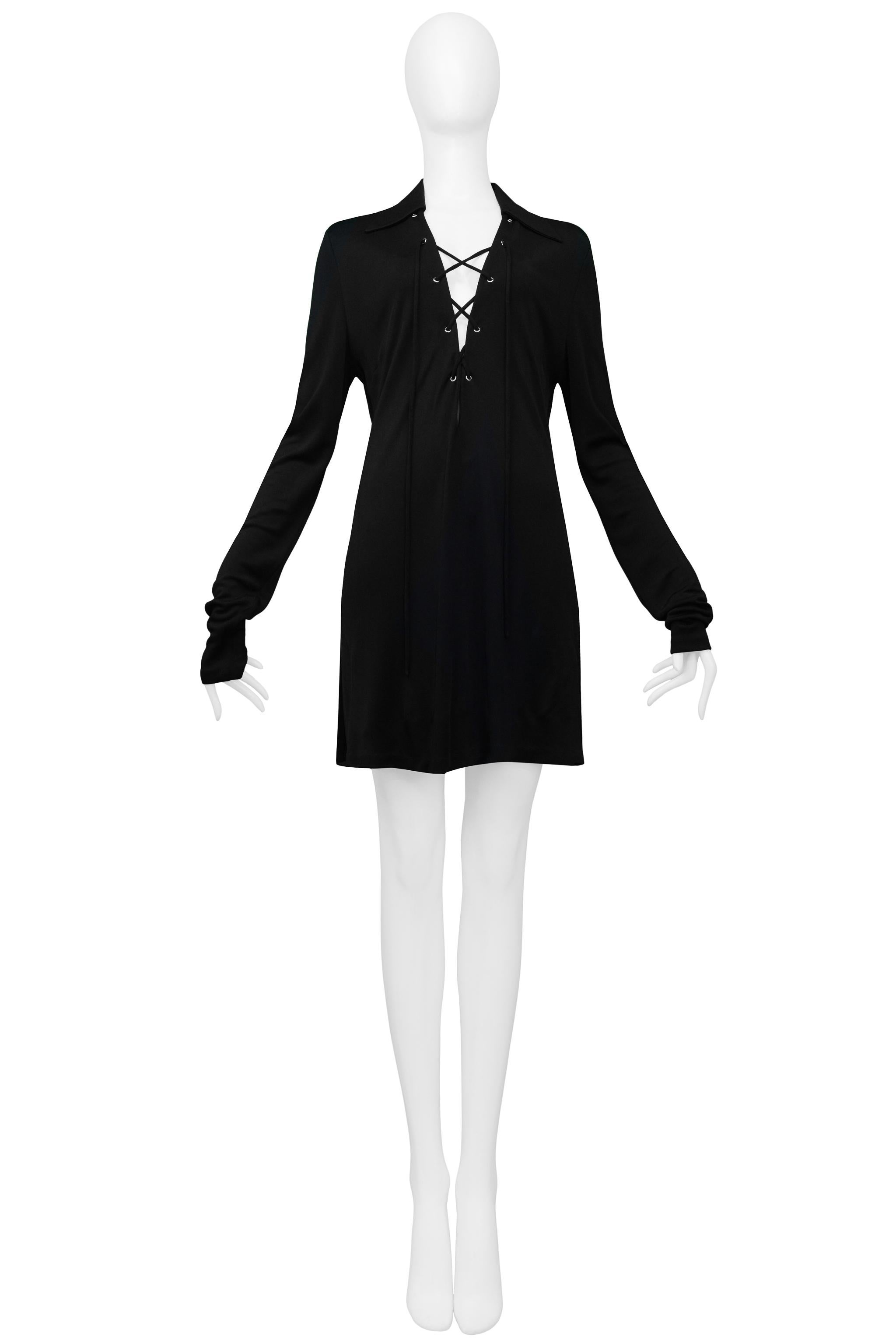 Resurrection Vintage is excited to offer a stunning vintage black Tom Ford for Gucci jersey mini-dress featuring iconic Safari-style lace front, wide collar, extra-long sleeves, and side slits. 

Gucci
Designed by Tom Ford
Size 46
Jersey
1996