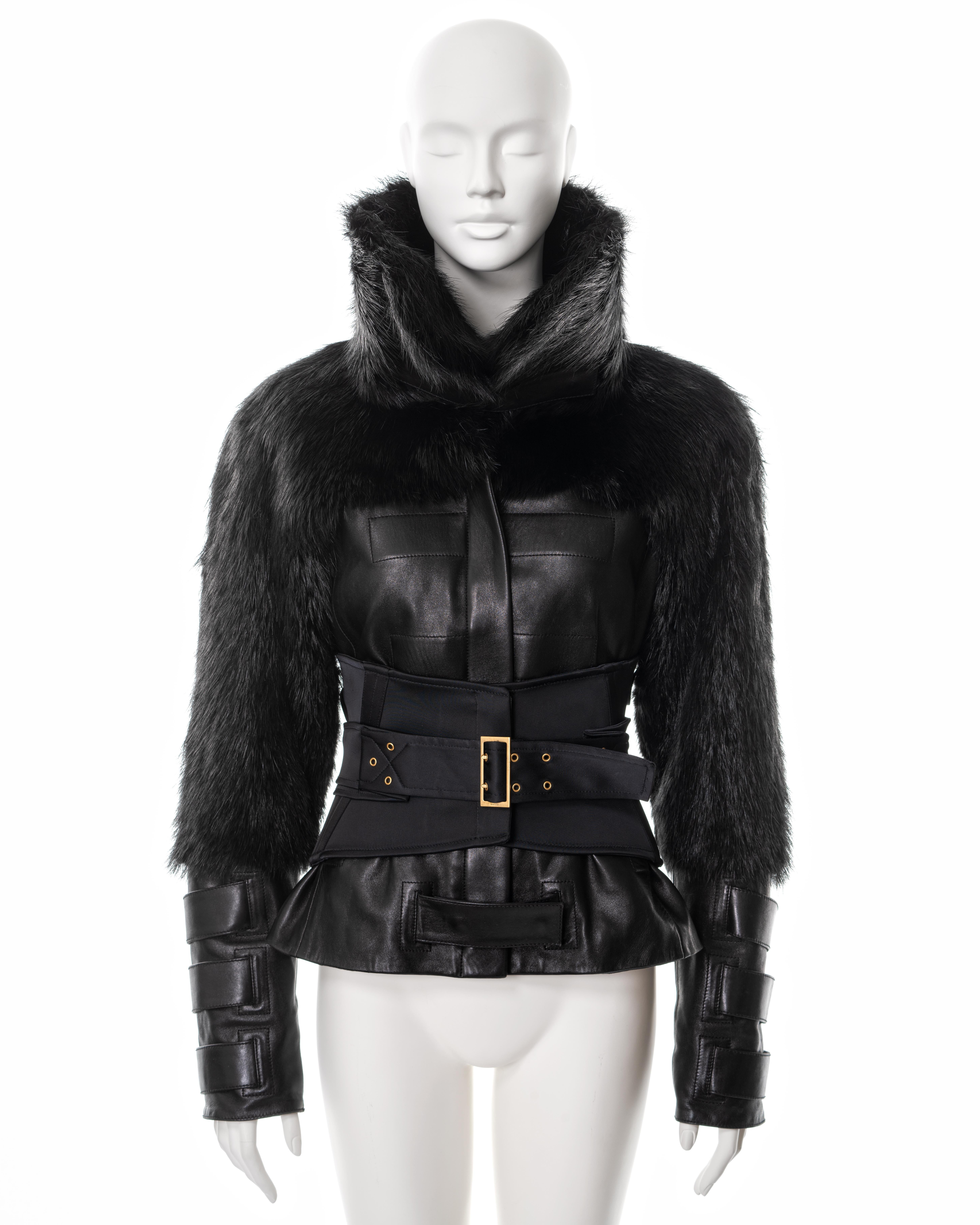 ▪ Gucci black leather and fur jacket 
▪ Designed by Tom Ford
▪ Sold by One of a Kind Archive
▪ Fall-Winter 2003
▪ Constructed from black leather and beaver fur 
▪ Large high-standing collar 
▪ Zip and press-stud closures 
▪ 3-strap detail on cuffs