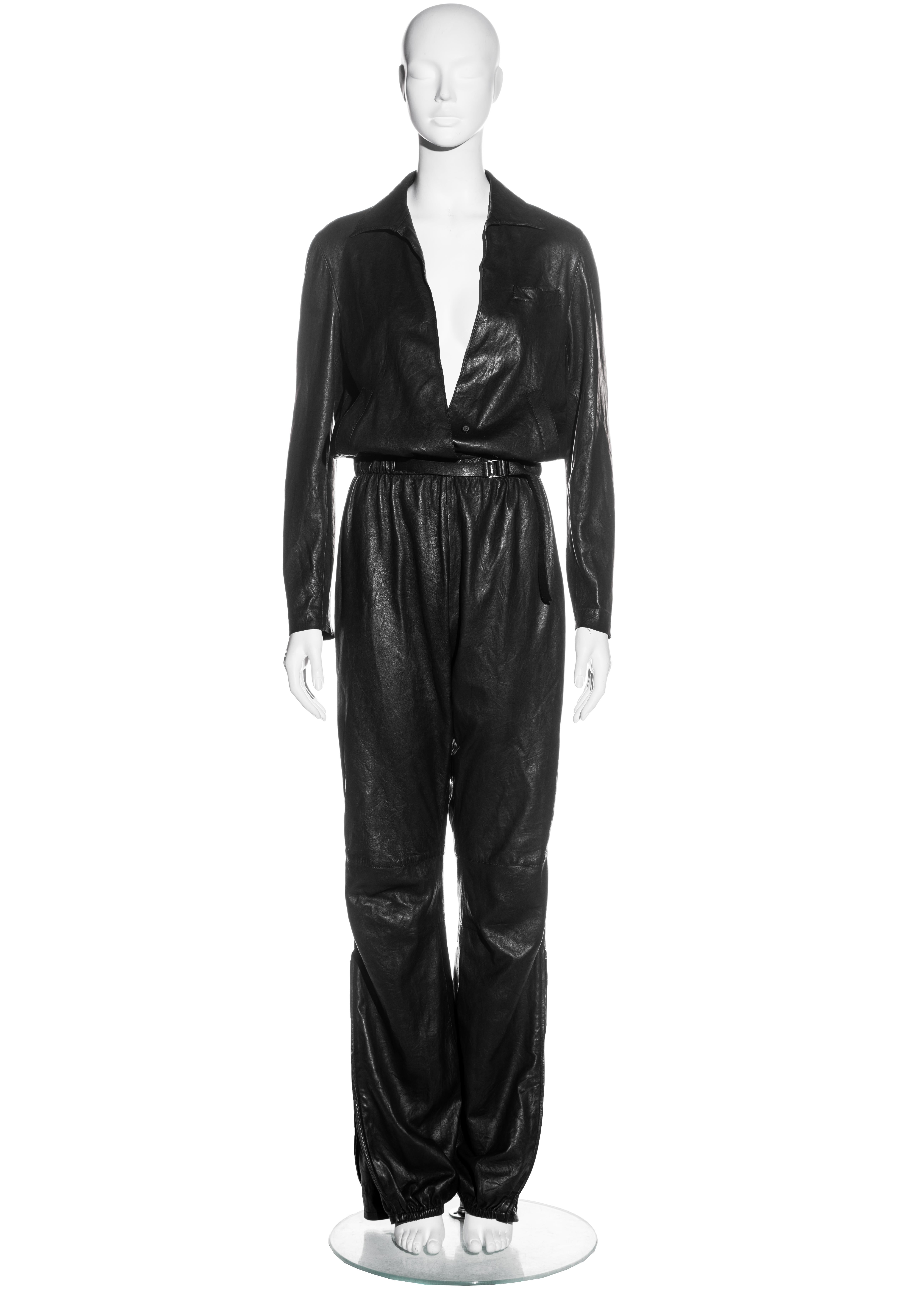 ▪ Gucci black leather jumpsuit
▪ Designed by Tom Ford
▪ Elastic at waistband and ankles 
▪ Etched 'Gucci' silver metal clasp at belt 
▪ Zips at ankles with long metal pulls 
▪ Low plunge with singular button fastening 
▪ IT 42 - FR 38 - UK 10 - US