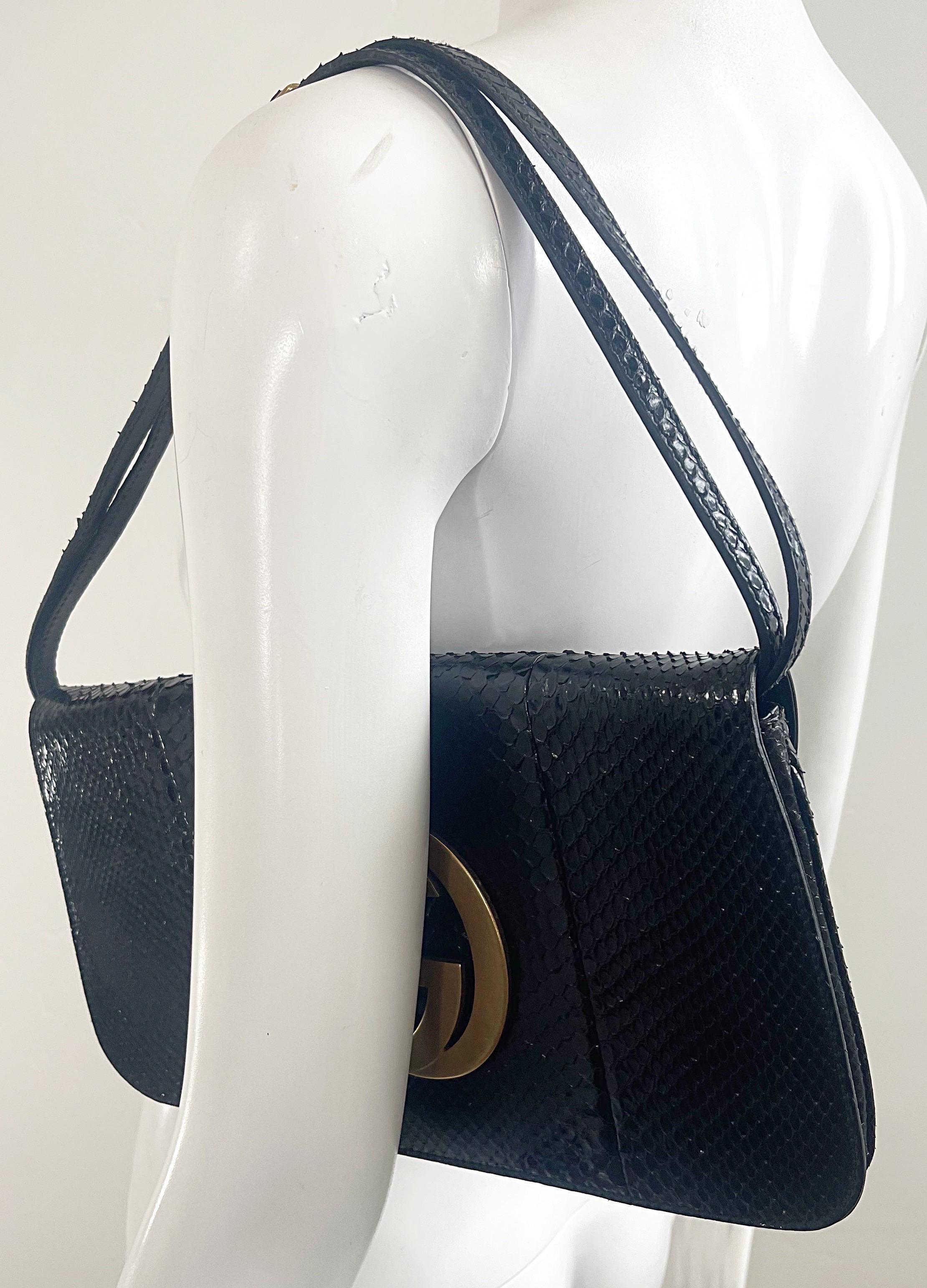 Beautiful early 2000s Y2K Tom Ford for Gucci black python snake skin convertible clutch, crossbody, or shoulder bag. Brushed matte gold GG logo. Snap closure with zipper pouch inside. Such a versatile piece that can be worn as a crossbody messenger