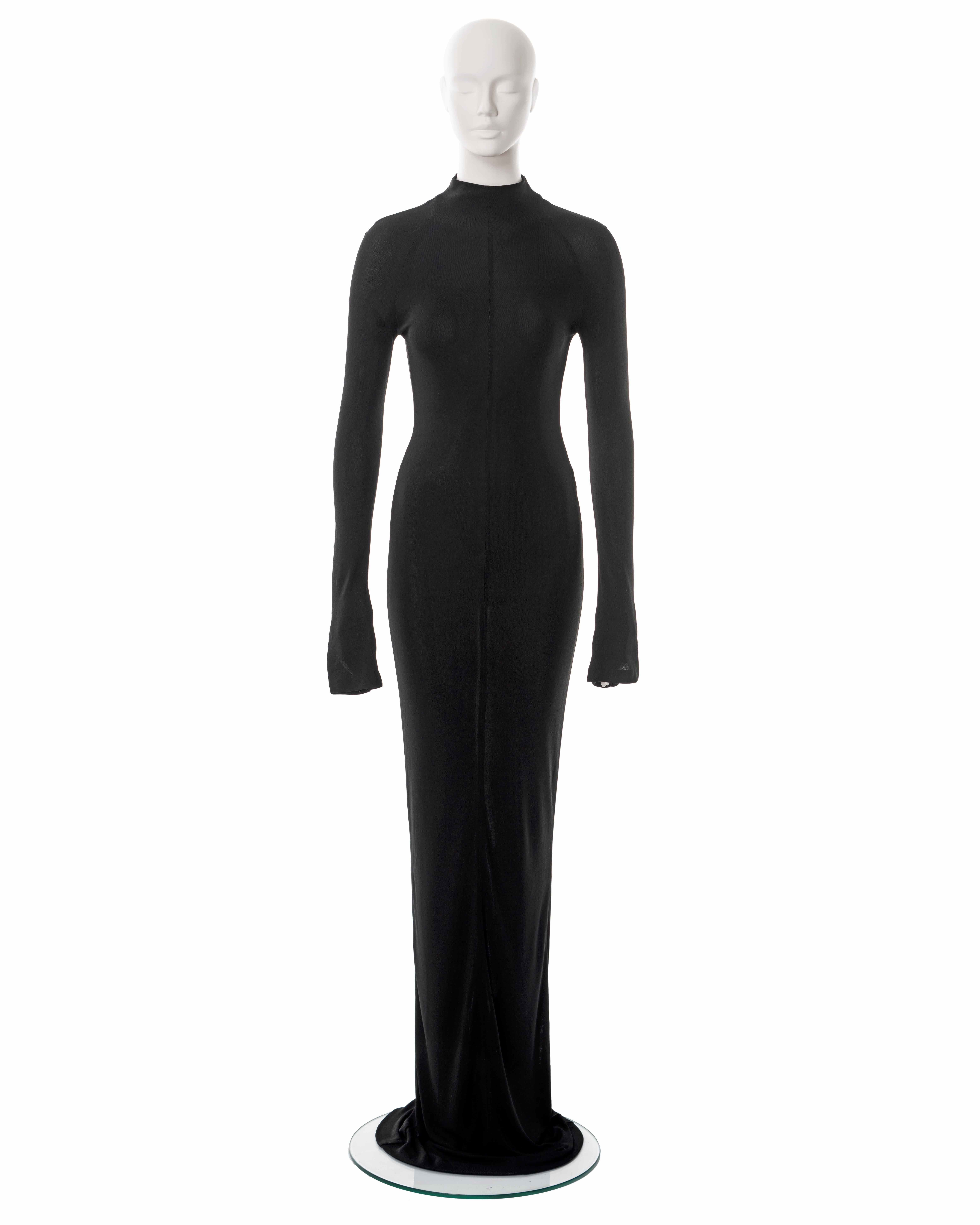 ▪ Gucci black rayon jersey evening maxi dress
▪ Designed by Tom Ford
▪ Sold by One of a Kind Archive
▪ Spring-Summer 1998
▪ Body-conscious fit 
▪ Extra long sleeves with slits at the cuff
▪ Mock neck 
▪ Concealed centre-back zipper 
▪ Extra Long