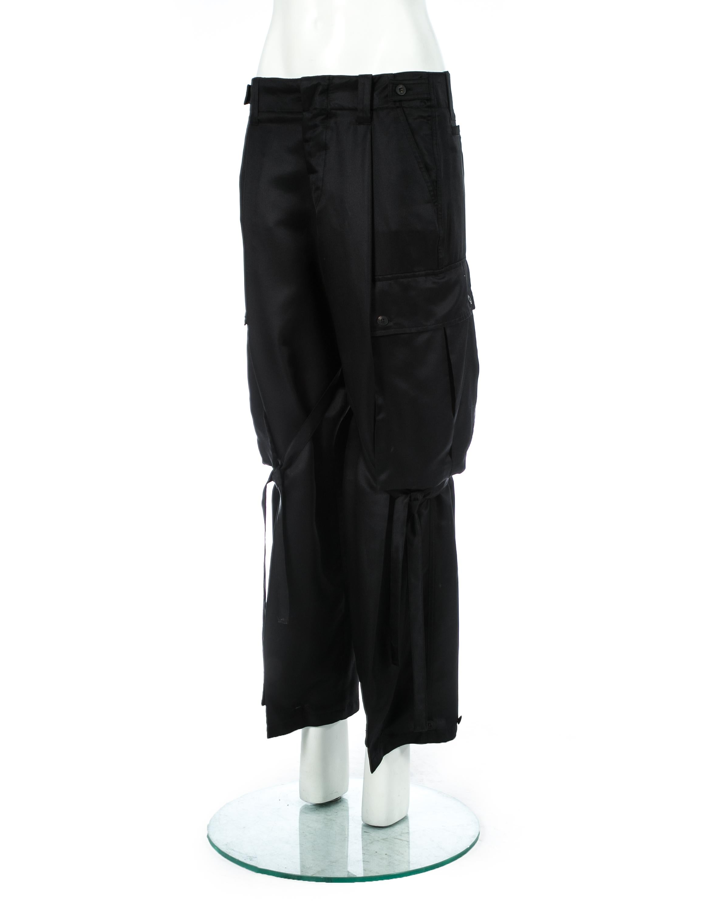 Gucci by Tom Ford; black silk cargo pants with oversized pockets and bondage ribbons fastening around the legs.

Spring-Summer 2001