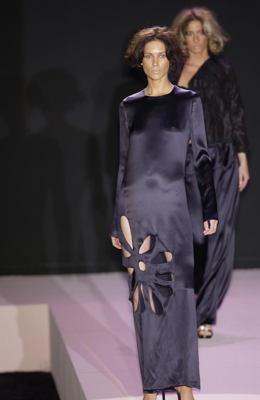 Gucci by Tom Ford black silk column dress with cut outs in the shape of a flower and leg slit on side seam

Spring-Summer 2002