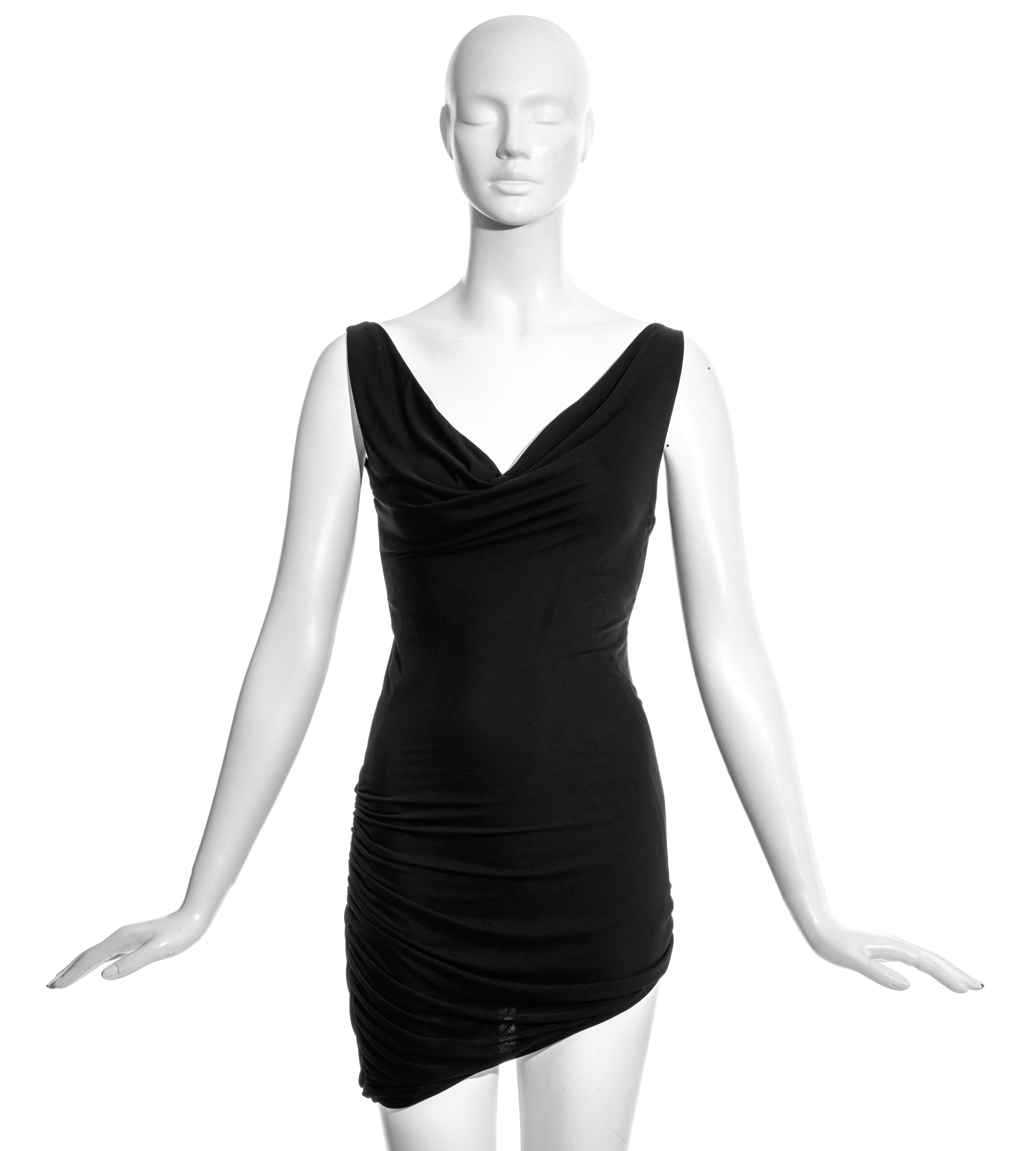 Gucci by Tom Ford black silk jersey mini dress with ruched side seam, asymmetric hemline and cowl neckline.

c. 2001