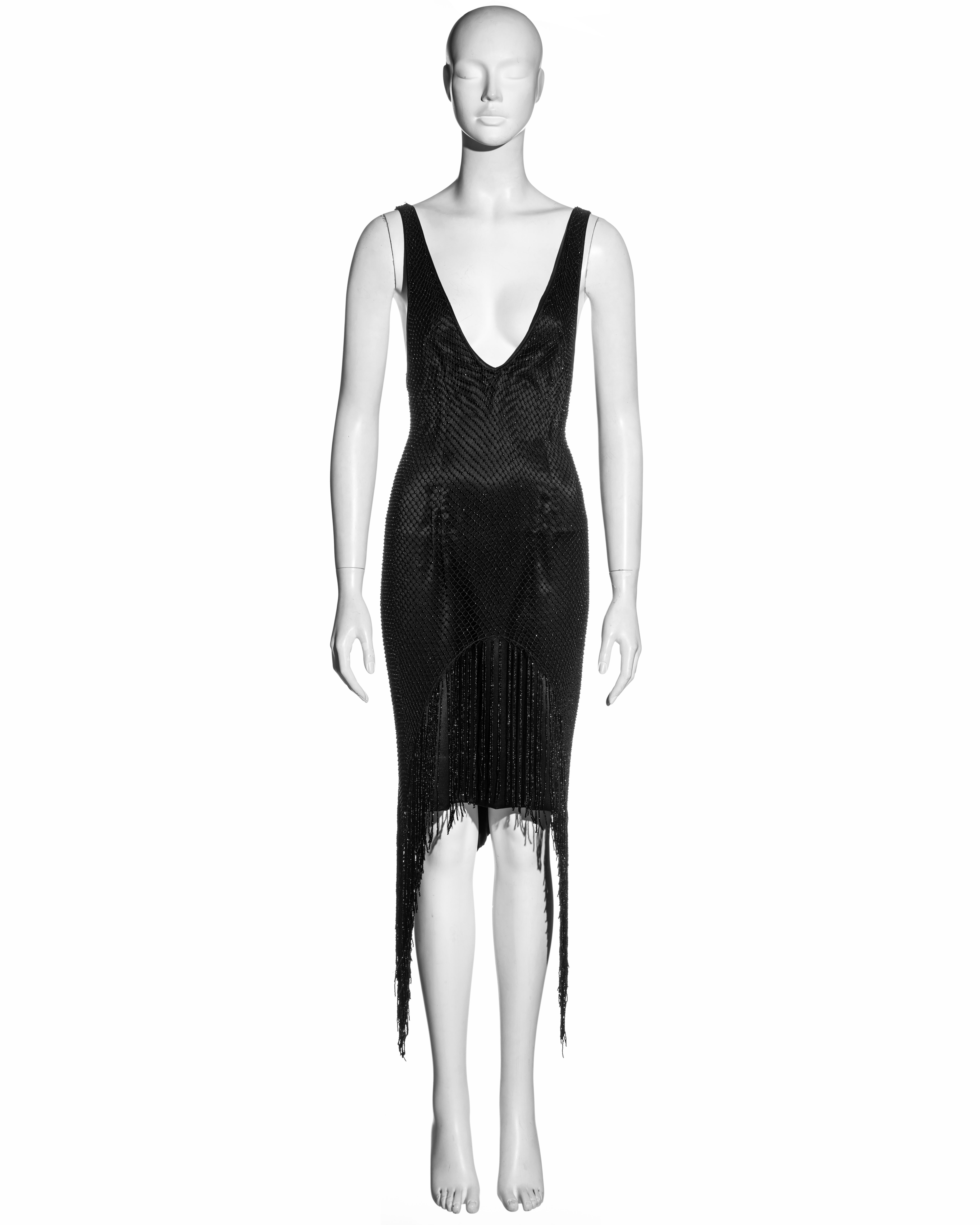 ▪ Gucci black silk evening dress
▪ Designed by Tom Ford
▪ Plunging v-neck
▪ Beaded net overlay 
▪ Beaded fringe trim 
▪ New with tags 
▪ IT 42 - FR 38 - UK 10 - US 6
▪ 100% Silk, 100% Rayon
▪ Fall-Winter 2002