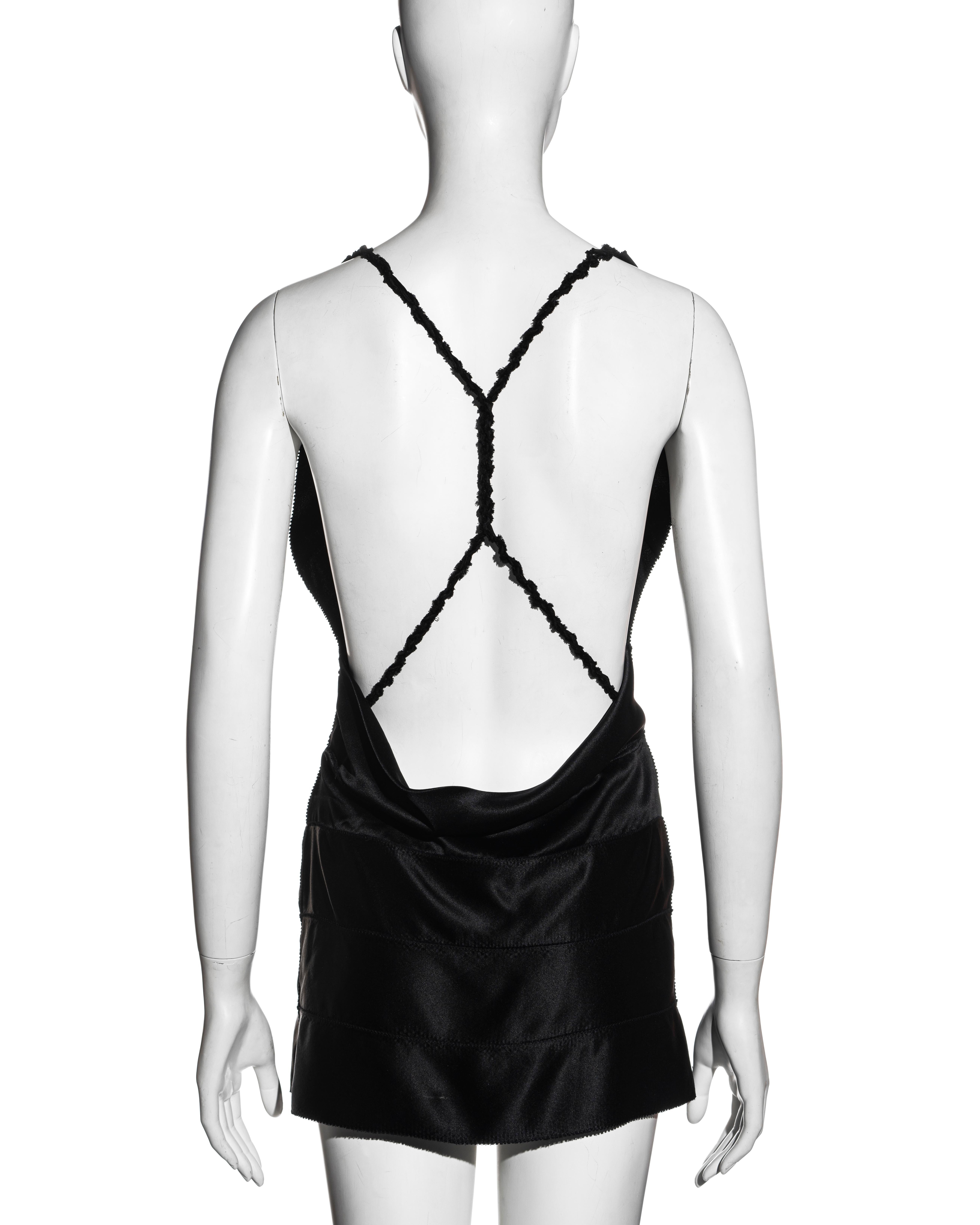 ▪ Gucci black silk mini dress
▪ Designed by Tom Ford 
▪ Constructed with multiple wide silk ribbons 
▪ Plunging neckline
▪ Braided shoulder straps crossing at the back 
▪ Micro mini skirt 
▪ IT 42 - FR 38 - UK 10
▪ Fall-Winter 2002