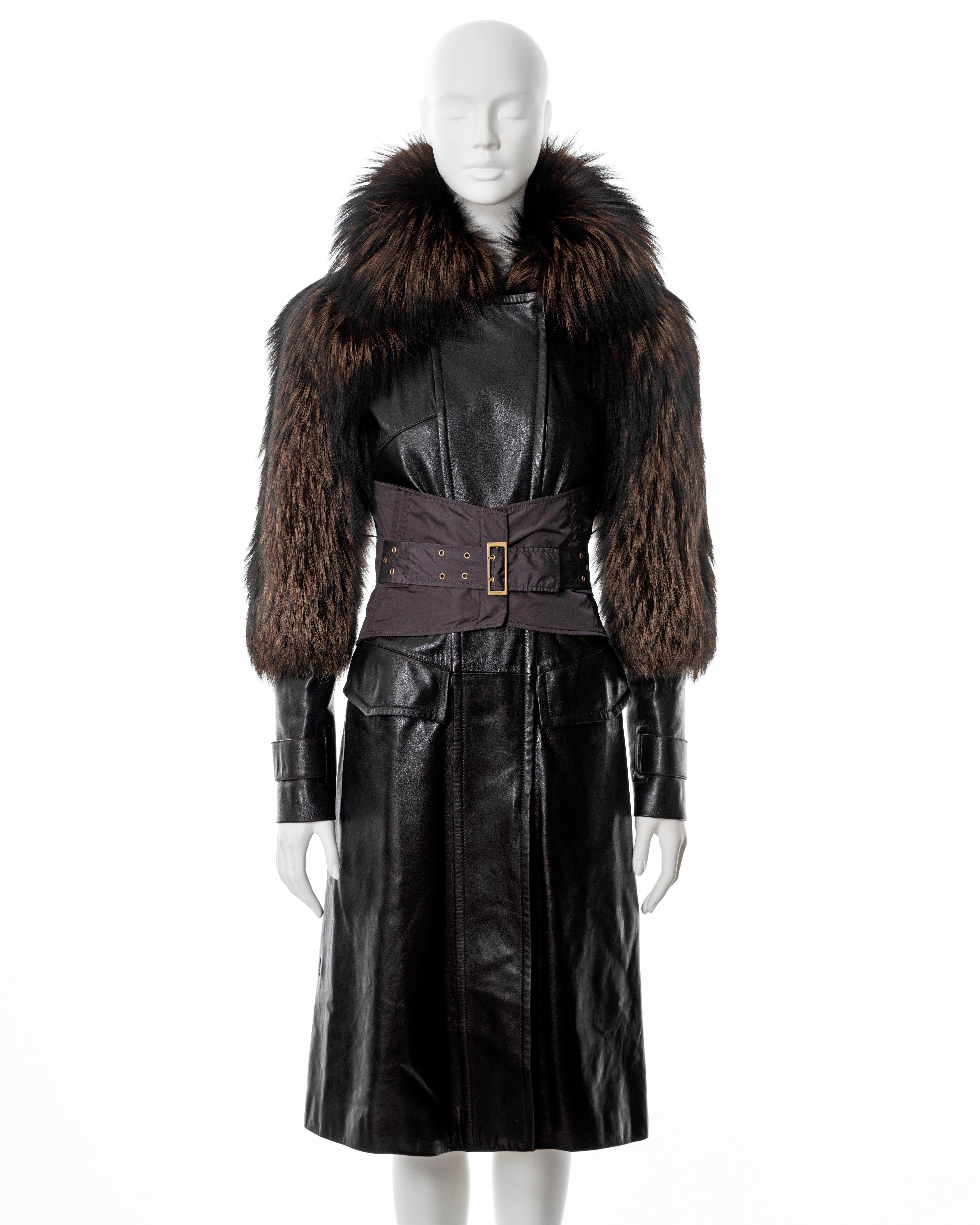 ▪ Gucci brown leather coat 
▪ Designed by Tom Ford
▪ Sold by One of a Kind Archive
▪ Fall-Winter 2003
▪ Constructed from dark brown leather and fox fur 
▪ Integrated corset with gold-tone hardware 
▪ 2 front flap pockets
▪ Double-ended front zipper