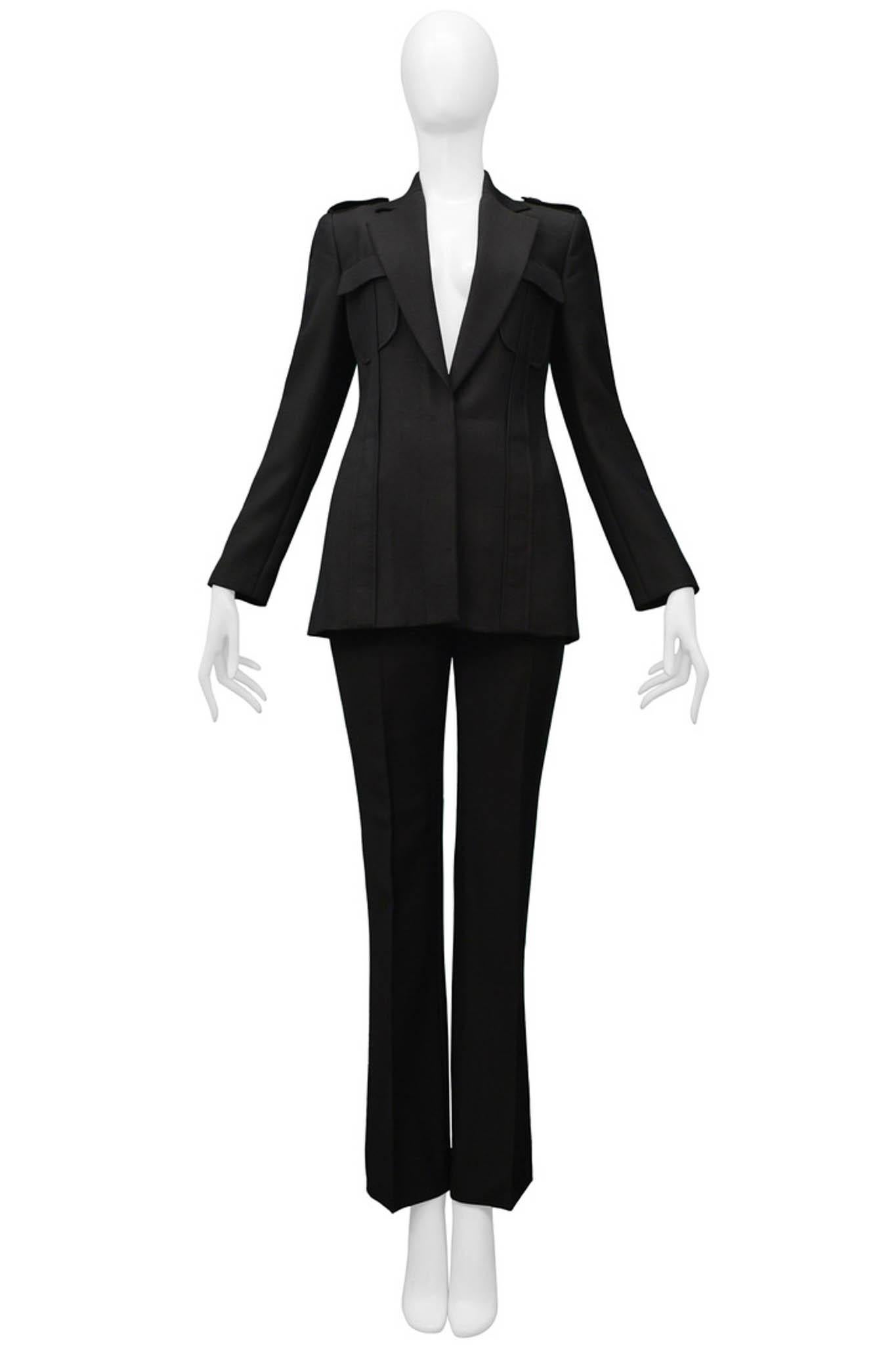 Resurrection Vintage is excited to offer a stunning vintage dark brown Tom Ford for Gucci pantsuit featuring a V-cut fitted blazer, wide lapels, epaulets, and two pockets. The pants feature a high waist and slim legs with a slight flare at the