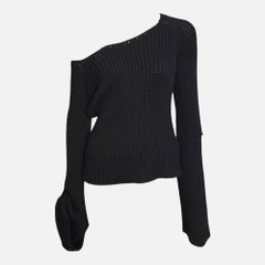 Gucci par Tom Ford, collection automne-hiver 2003 : pull noir en maille côtelée, à une seule épaule et à manches cloche, orné d'une boucle en cuir