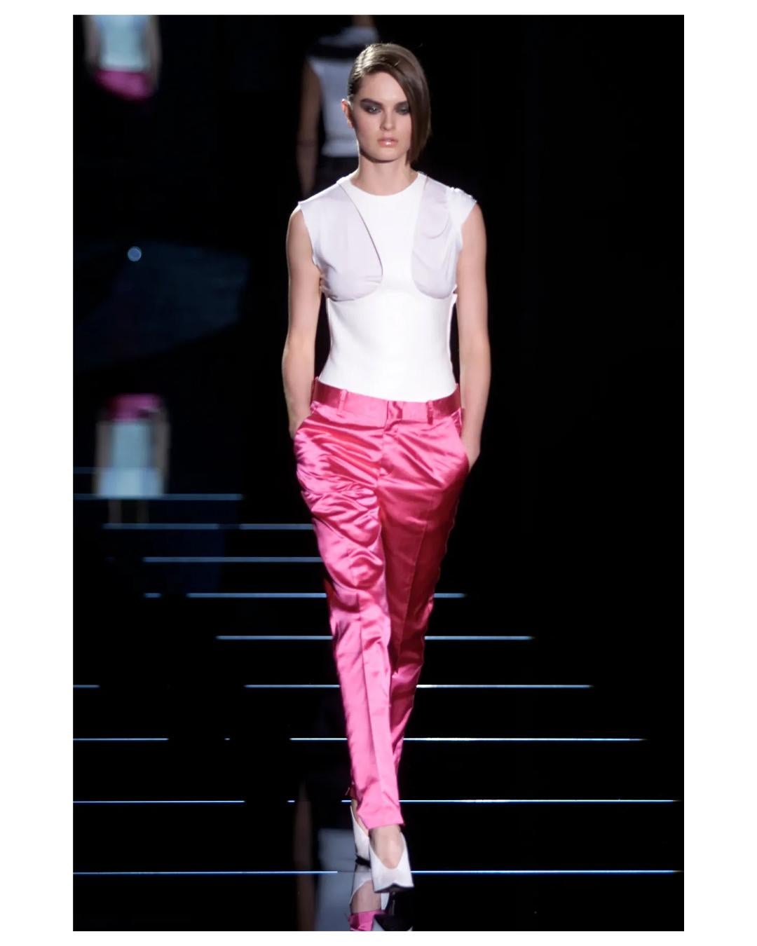 LOVE LALI Vintage

Gucci by Tom Ford Fall 2001 hot fuchsia pink tapered dress pants with a low rise waist in silk
Belt loops
Creases
Two front pockets 
Ankle zips with Gucci engraved zipper pulls
The pants sit quite long due to the fact they are low