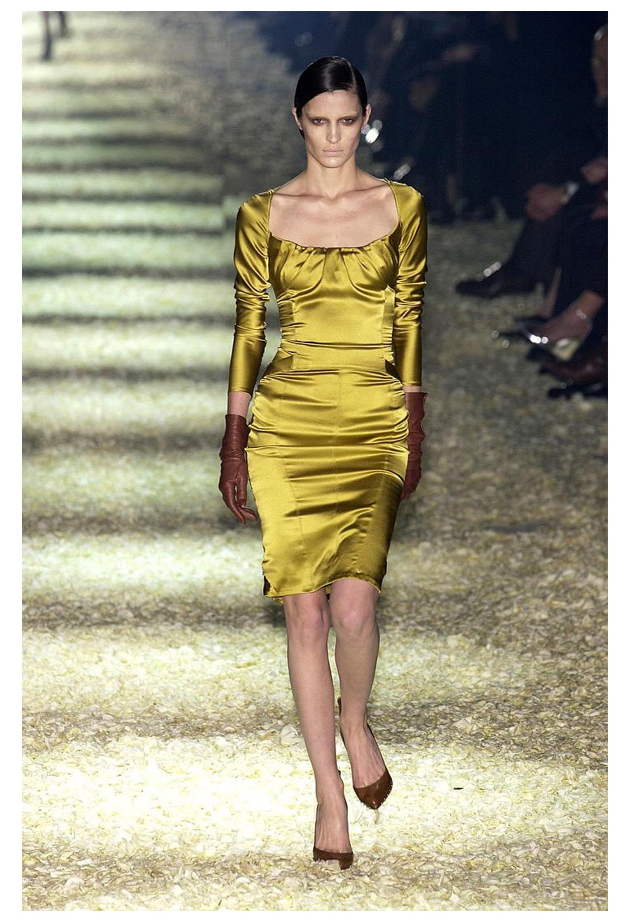 Resurrection Vintage is excited to offer a stunning gold 2003 Tom Ford for Gucci corset dress featuring a pleated corset-shape neckline and bodice, long sleeves, satin fabric with stretch, girdle skirt detailing, center back zipper, and knee