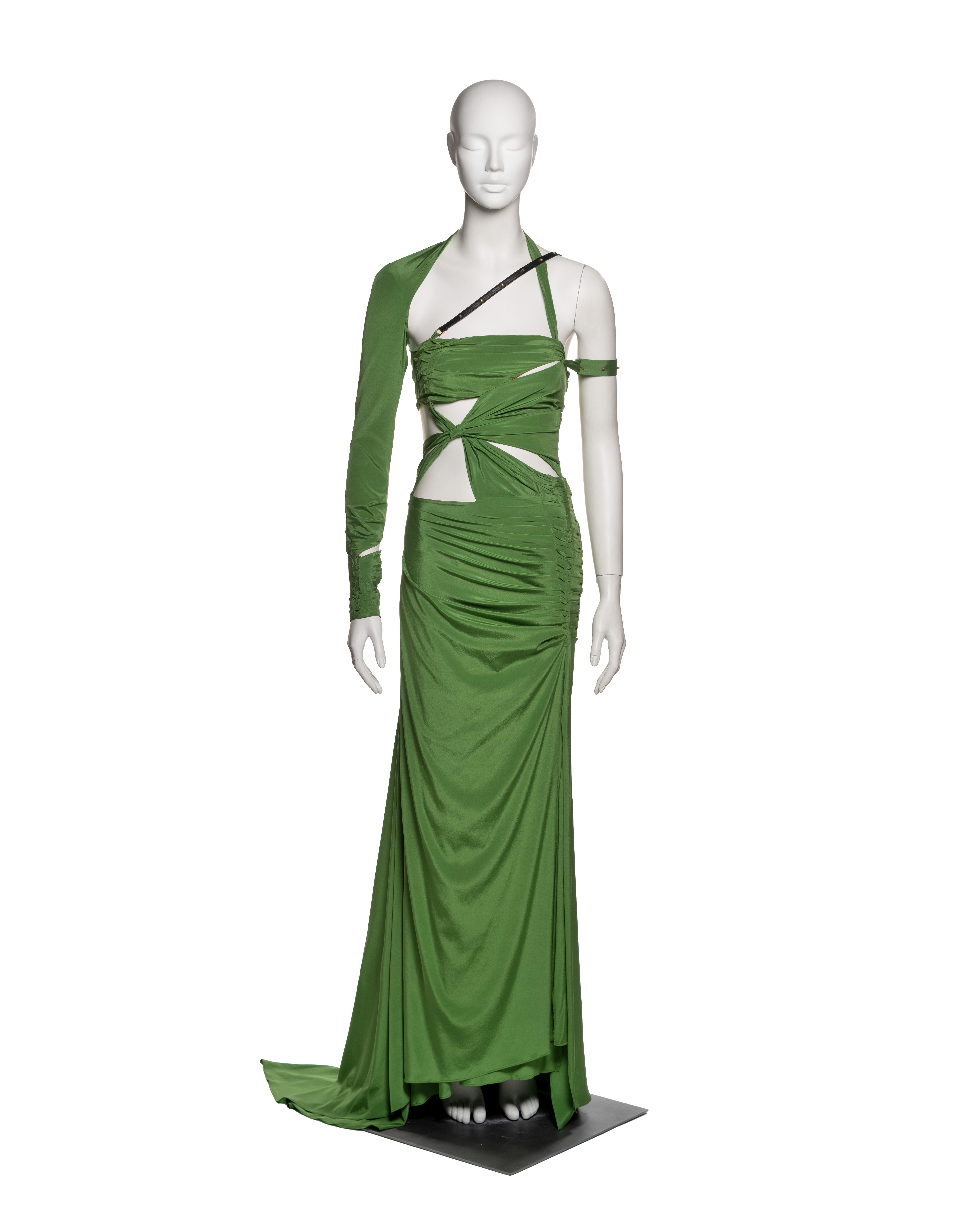 Asymmetric floor-length dress by Tom Ford for Gucci, from the Fall-Winter 2003 collection. Constructed in green silk, the design showcases a complex network of ruching, wrapping, and cut-outs that expose the midriff, back, and shoulder. The bodice