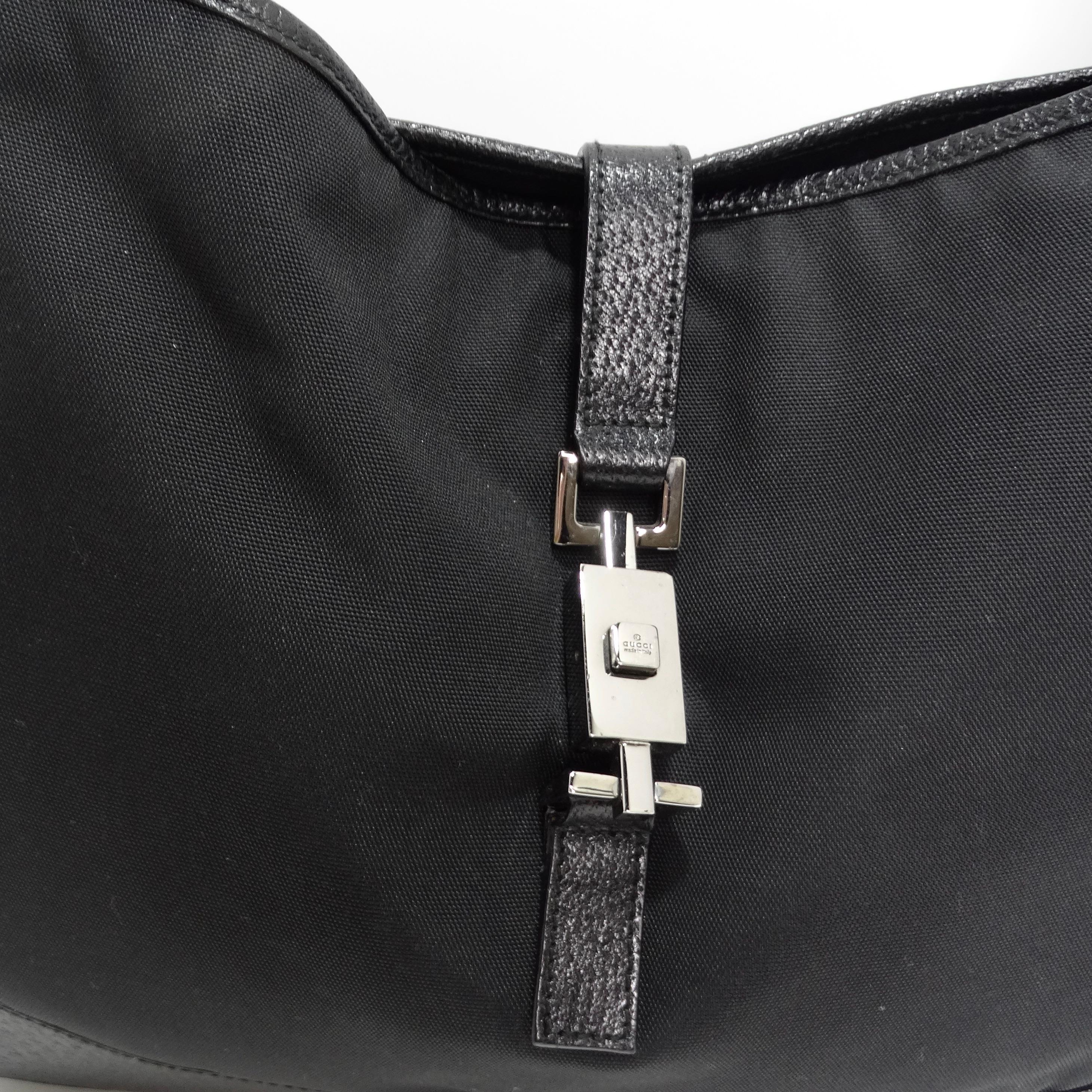 Introducing a handbag that combines iconic style with practicality - the Gucci by Tom Ford Jackie O Nylon Handbag in Classic Black. This hobo shoulder bag is a testament to timeless design and quality, making it an ideal choice for your everyday