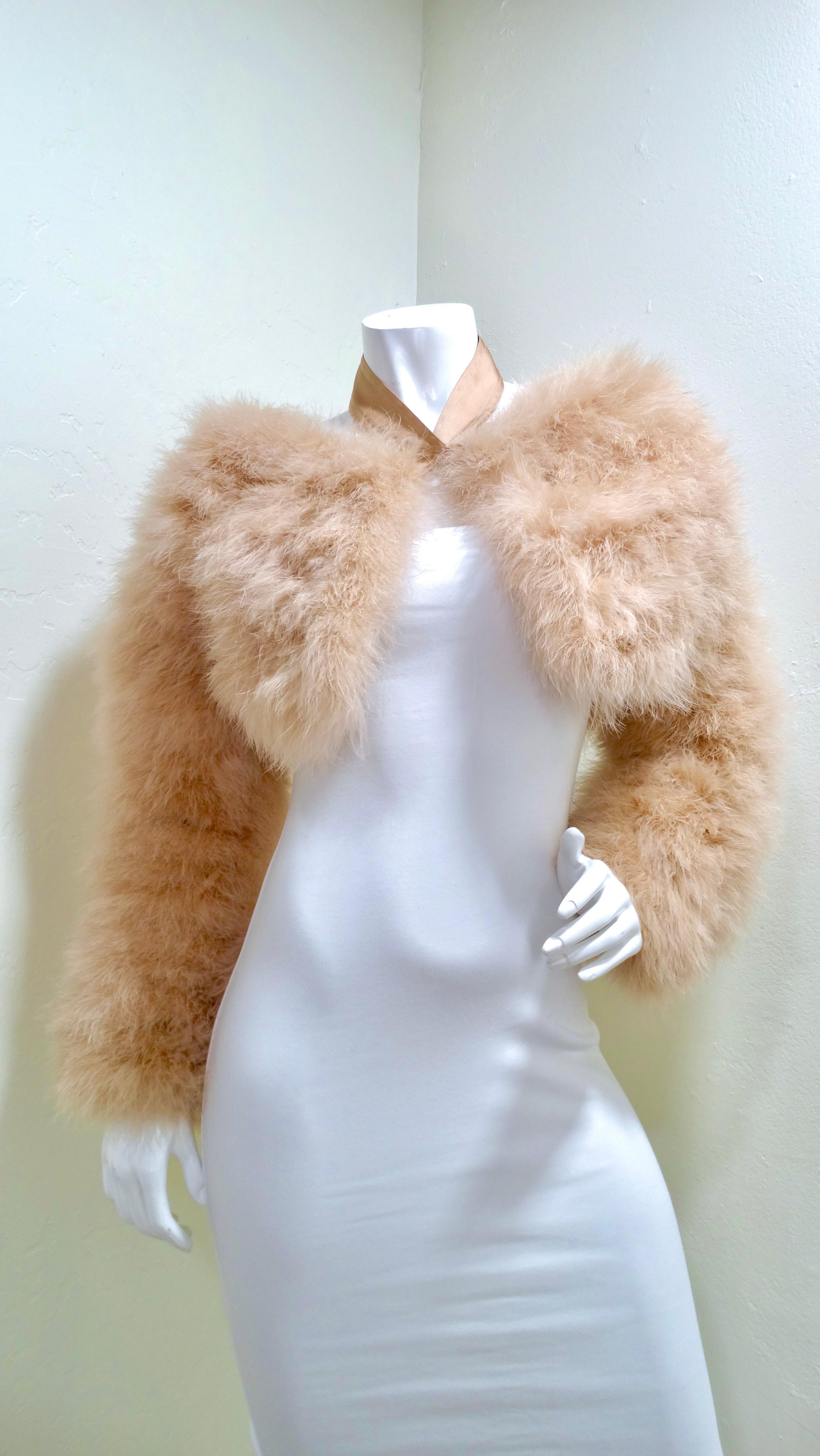 Don't miss out on this opportunity to get your hands on this beautiful iconic  bolero by Tom Ford for Gucci! This is featured in a baby pink Marabou feathers in a cropped silhouette and long sleeves. Shown on the runway show SS 2004, this is a