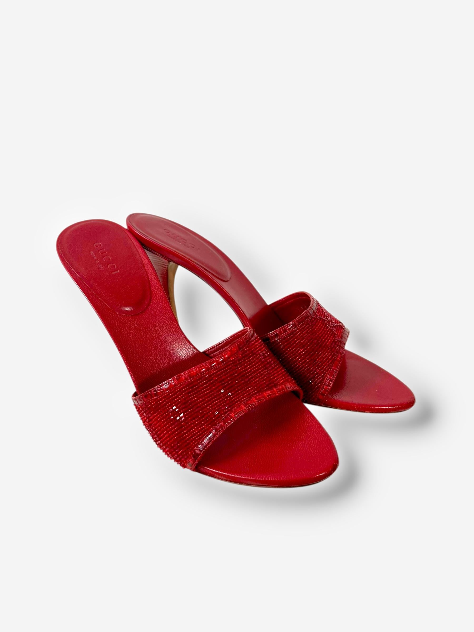 

Gorgeous and sultry red open-toe heels from Tom Ford’s era at Gucci, featuring intricate tone-on-tone beading across the wide front strap for a subtle shimmer. The minimal silhouette, paired with the signature sensuality of early 2000s Gucci,