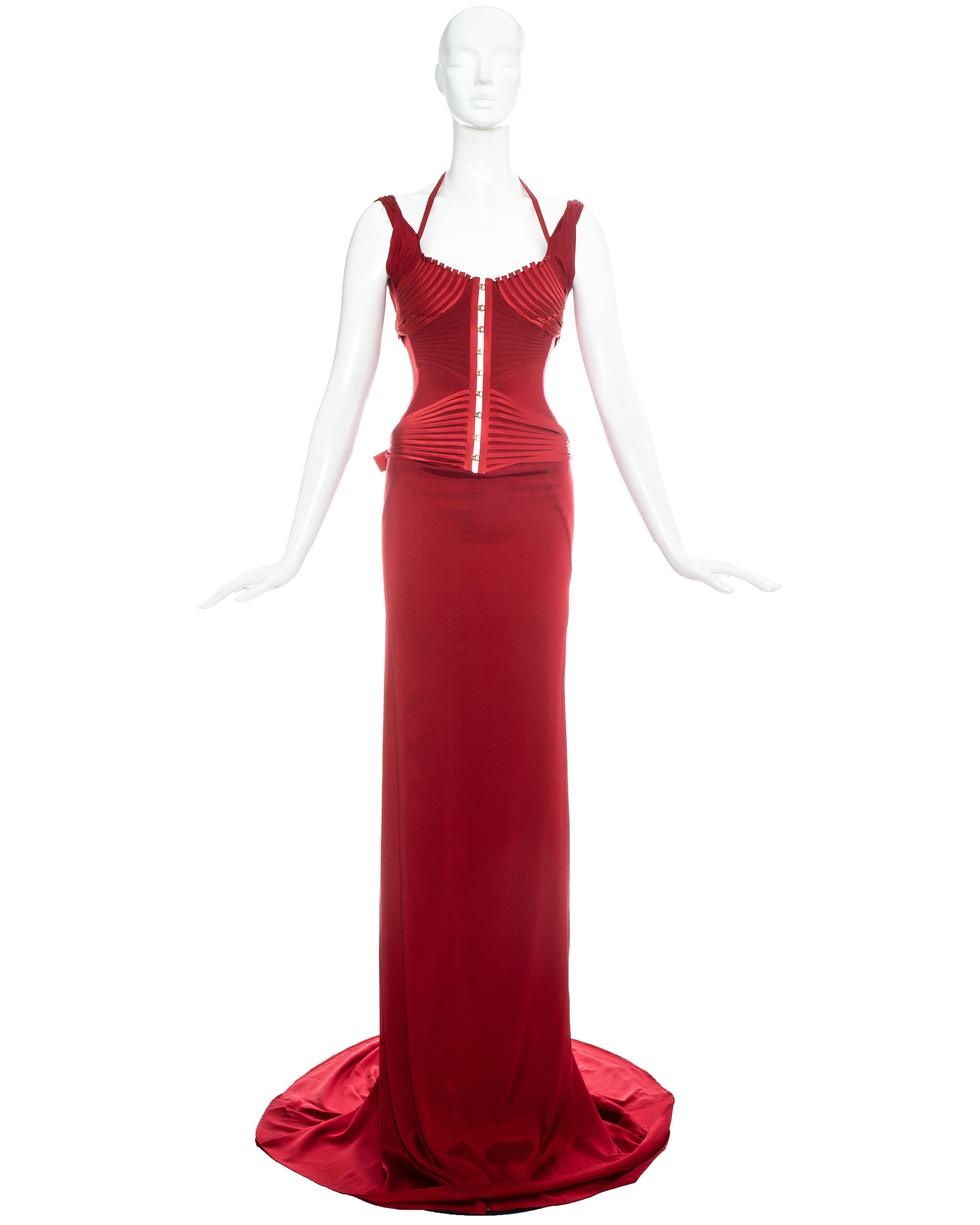 Gucci by Tom Ford red silk corseted trained evening dress with appliquéd ribbons around bodice, hook closures down centre front and four buckle fastenings on the sides

Fall-Winter 2003