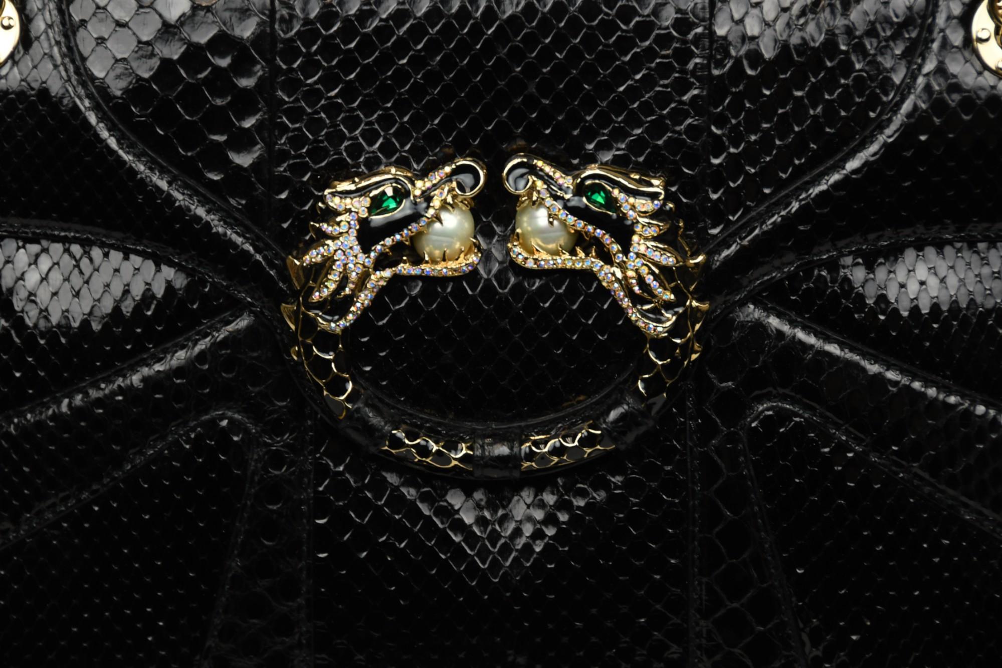 From the Fall/Winter 2004 collection under Tom Ford’s visionary direction, this Gucci flap bag is a rare collector’s piece crafted from genuine black python leather. Its bold yet refined silhouette is accented by an iconic gold-tone dragon-head ring