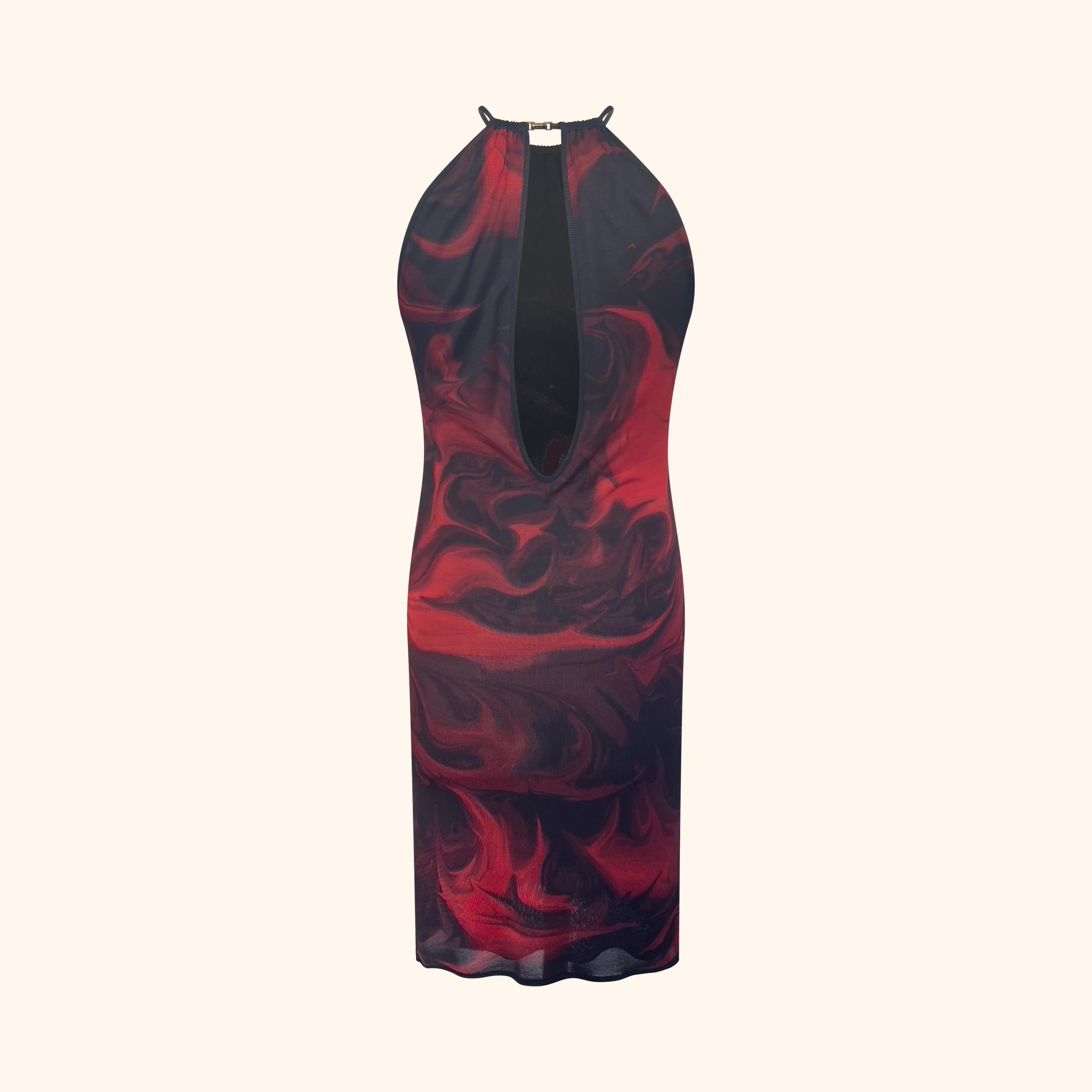 Robe formulée avec l'imprimé emblématique de lave rouge et noire de la collection printemps/été 2001.
Il présente un décolleté haut fixé par une lanière de cuir et un fermoir en métal doré, ainsi qu'un dos partiellement ouvert.
Cet imprimé a