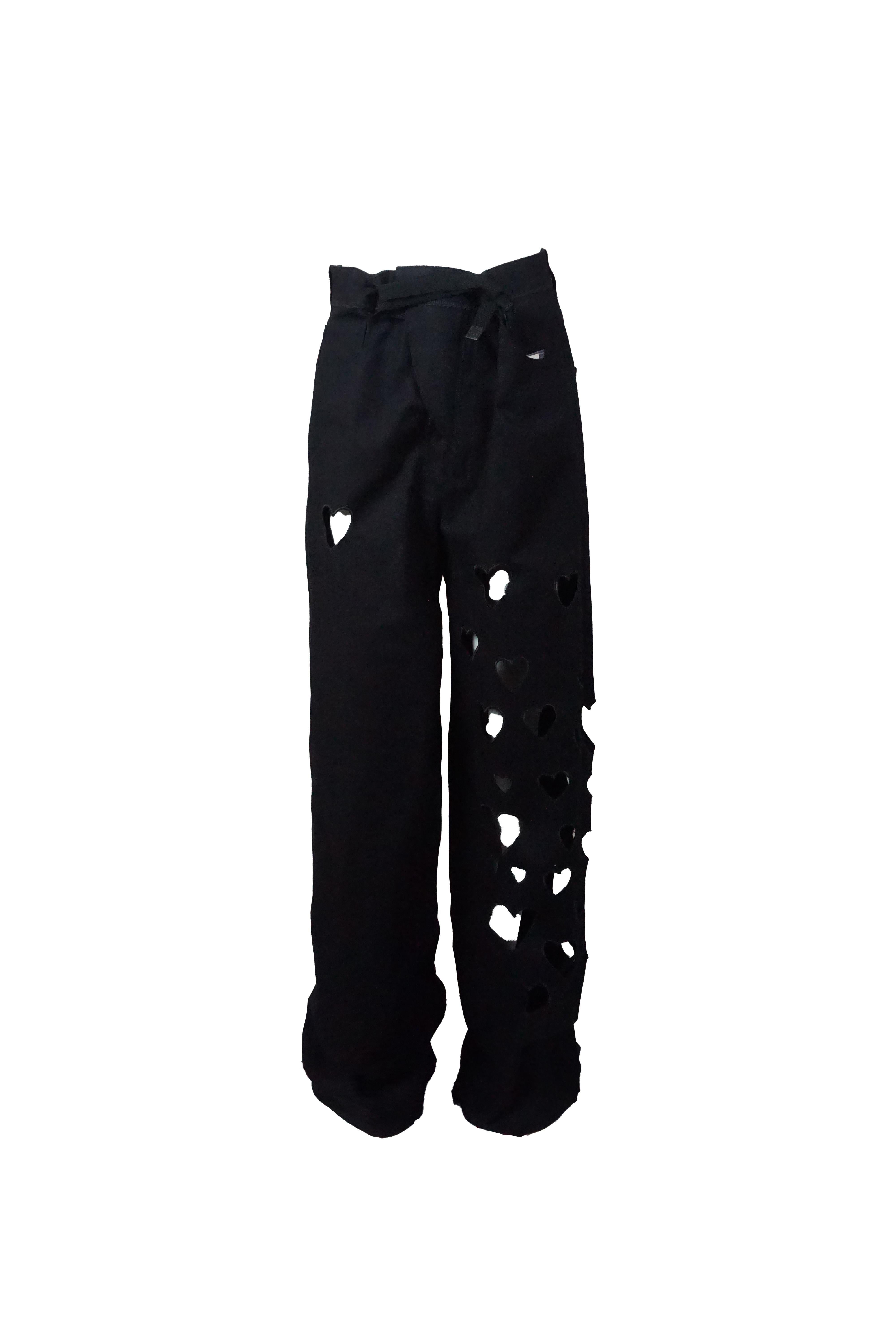These bold and playful black oversized wide-leg pants from GUCCI spring 2002 collection feature unique heart-shaped cutouts cascading along one leg, adding a flirty and modern edge to a classic silhouette. The waist belt allows adjustment to fit
