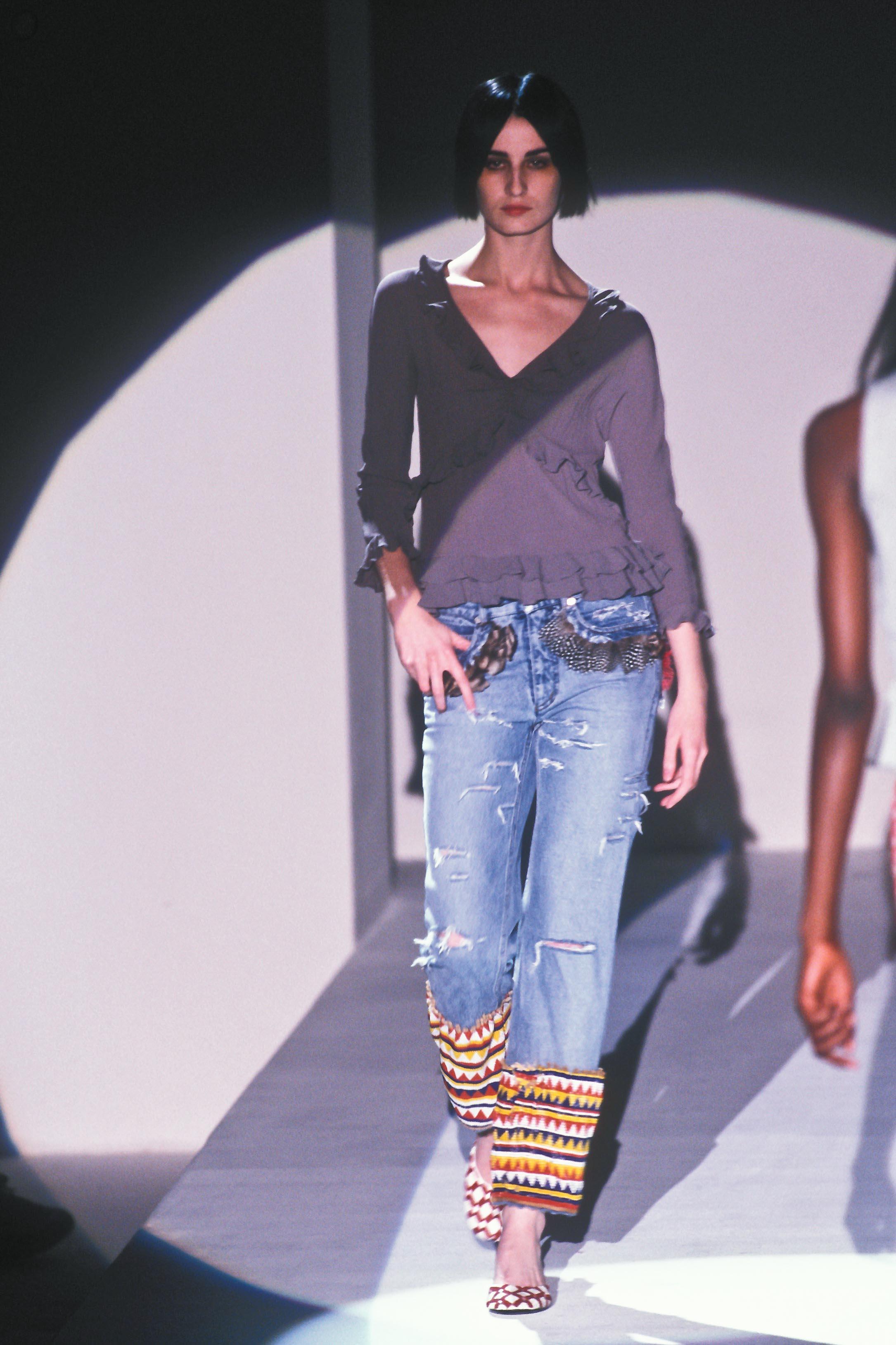 Gucci by Tom Ford Spring/Summer 1999 light blue distressed jeans with heavily beaded legs, feather covered back pockets, feather trimmed front pockets, and beading all around the waistband.

As worn on the runway.

One of the most iconic Tom Ford