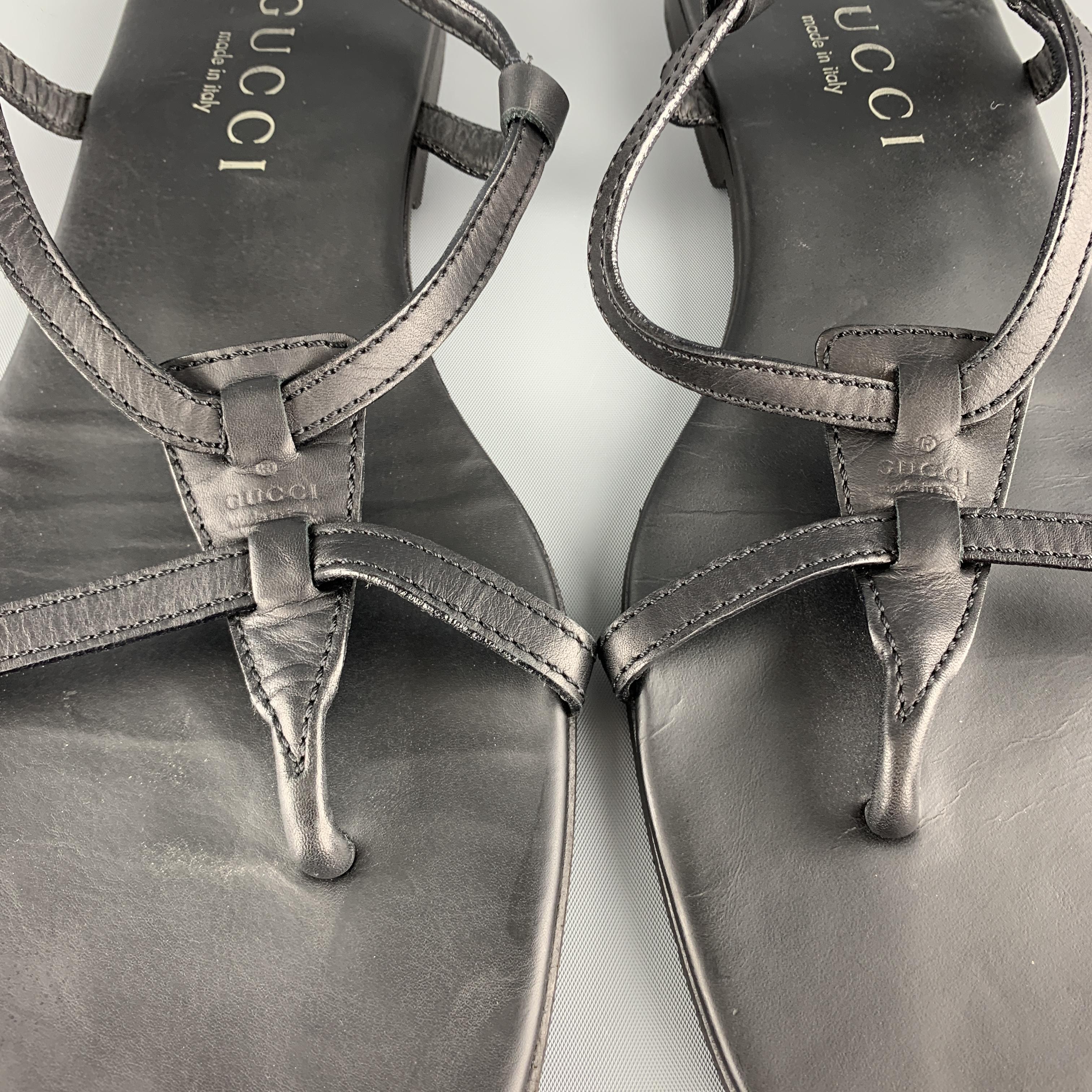 GUCCI by TOM FORD sandals come in black leather with an ankle harness and thong strap with embossed logo. With Dust Bag. Made in Italy.

Very Good Pre-Owned Condition.
Marked: UK 9

Outsole: 11 x 4.25 in.