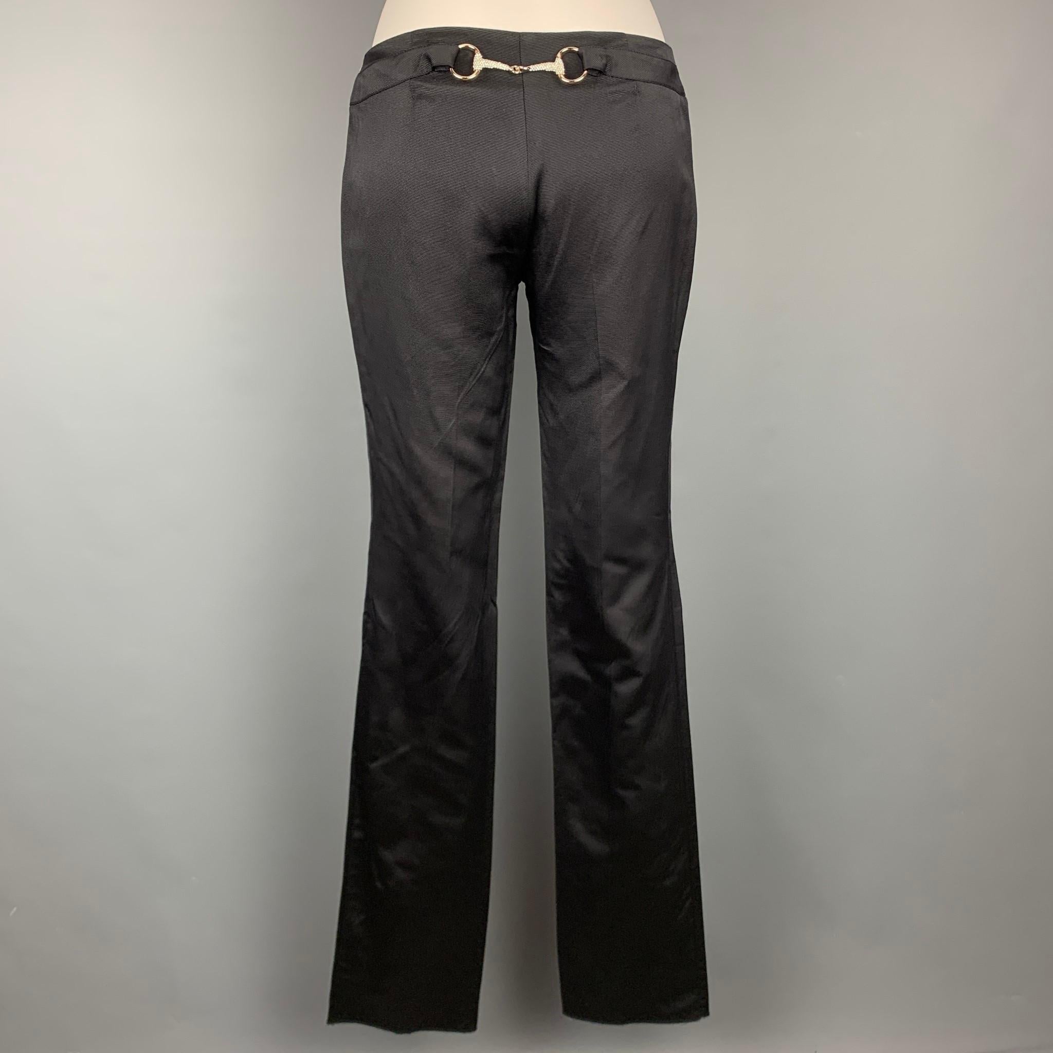 GUCCI by TOM FORD dress pants comes in a black ribbed silk / cotton featuring a straight leg, front tab, back rhinestone horse bit detail, and a zip fly closure. Made in Italy.

Very Good Pre-Owned Condition.
Marked: IT 38

Measurements:

Waist: 30