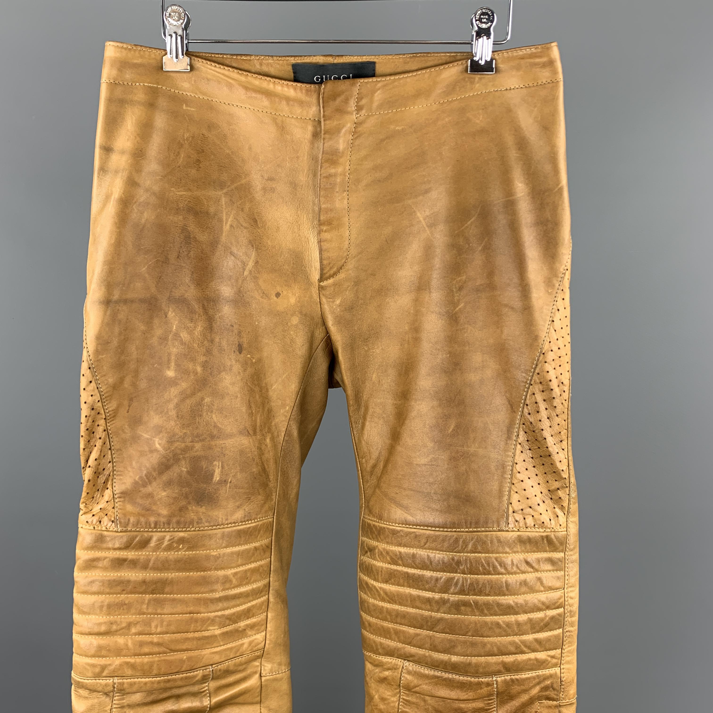 Archive early 2000s GUCCI by TOM FORD biker style pants come in soft tan leather with a zip fly, perforated side panels, quilted knee pads, and zip and tab hems. Wear throughout leather and liner damaged. As-is. Made in Italy.

Good Pre-Owned