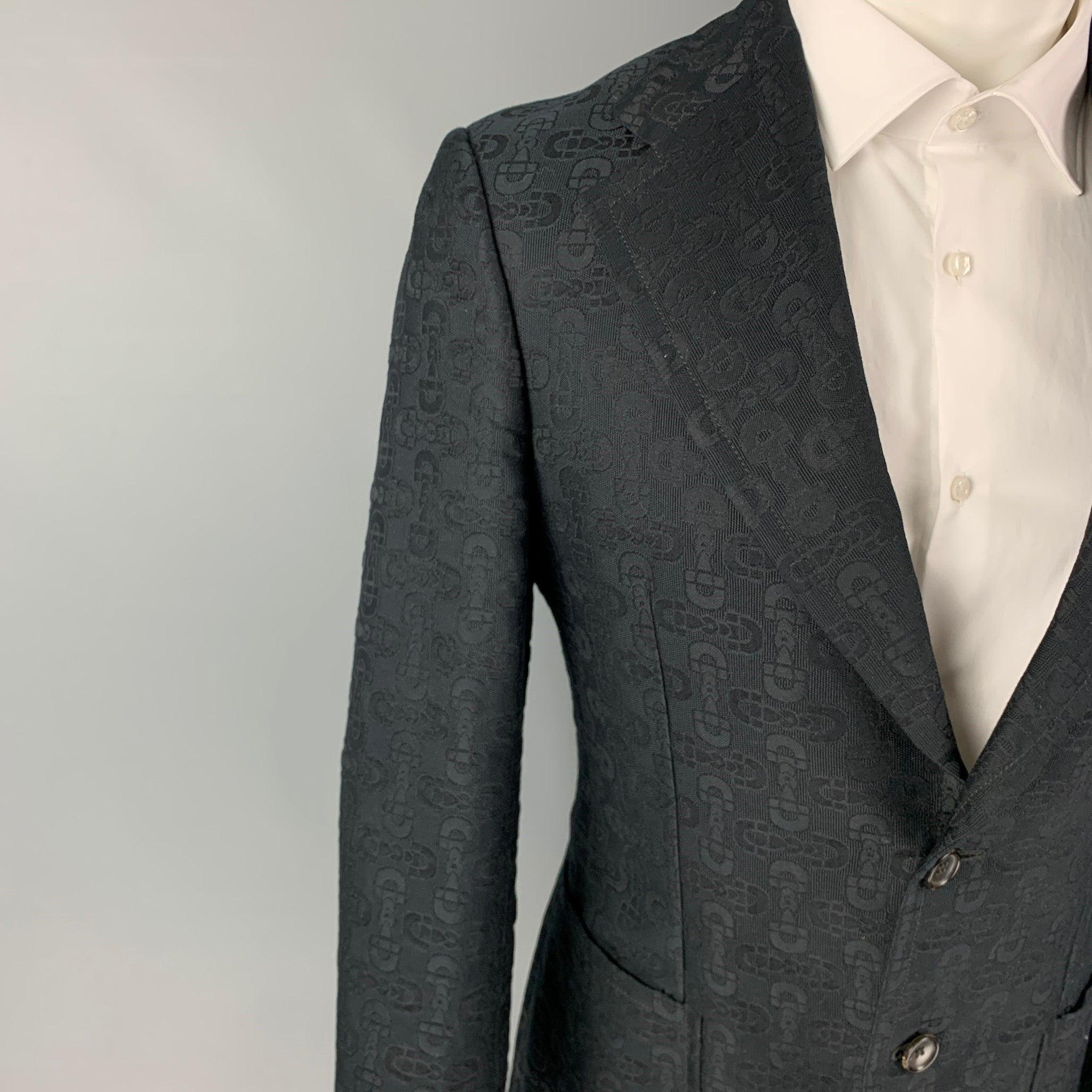 GUCCI by TOM FORD sport coat comes in a black jacquard cotton / silk with a full liner featuring a notch lapel, patch pockets, double back vent, and a double button closure.
Excellent
Pre-Owned Condition.  

Marked:   46 R 

Measurements: 
