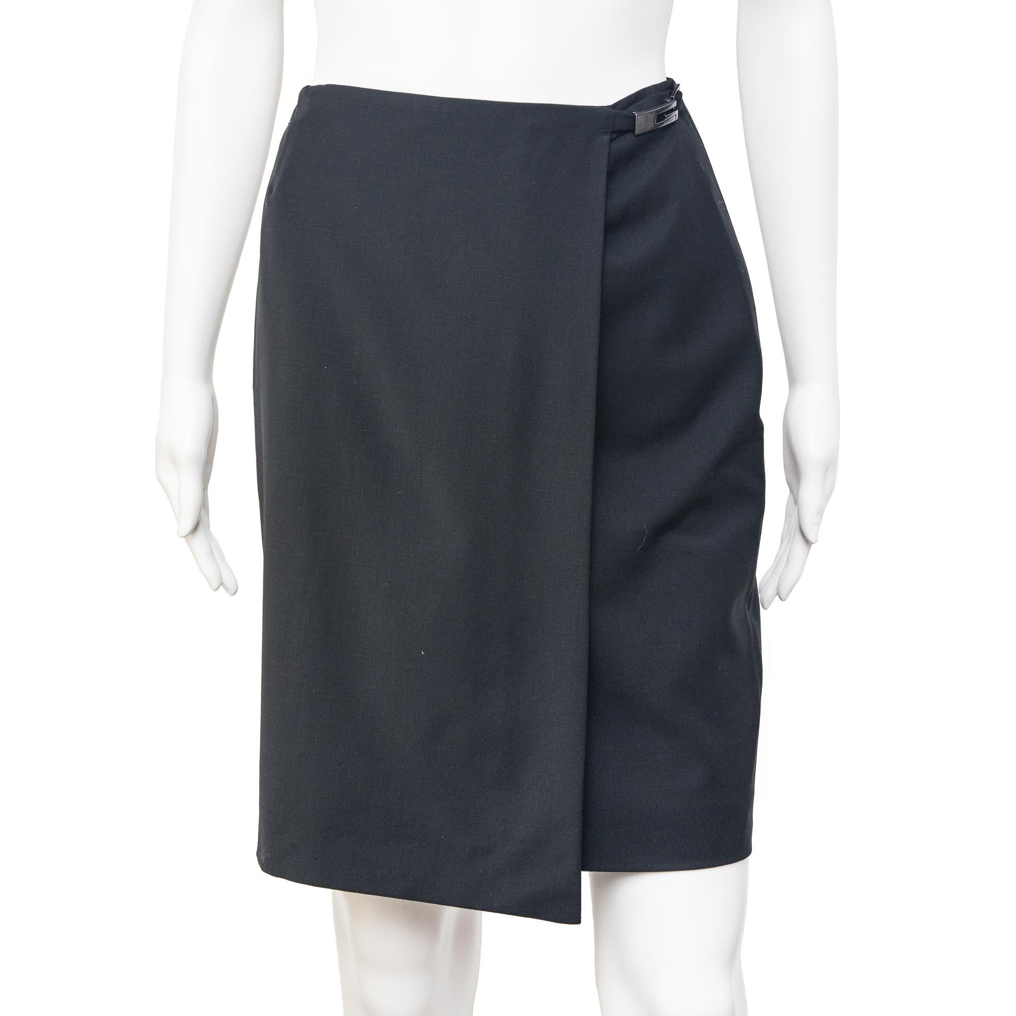 Ruder Than The Rest presents a spring-summer 1998 Gucci wrap skirt in black.

Gunmetal grey G logo buckle at the side of the hip.

Designed by Tom Ford.

Wool mix which is stretchy and figure-hugging.

Knee length.

Silk mix lining.

Vintage,