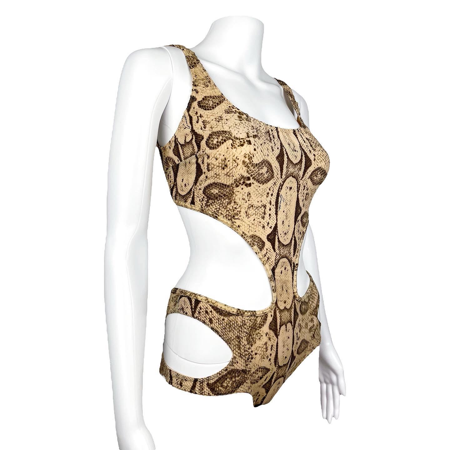 Gucci by Tom Ford Spring 2000 iconic snakeskin print swimsuit as seen on both the runway and the campaign. The swimsuit has cutout on each hips, and is open on the front and back too. 
Size XS/S. Fits true to size. 
Condition: Excellent / Flaws: