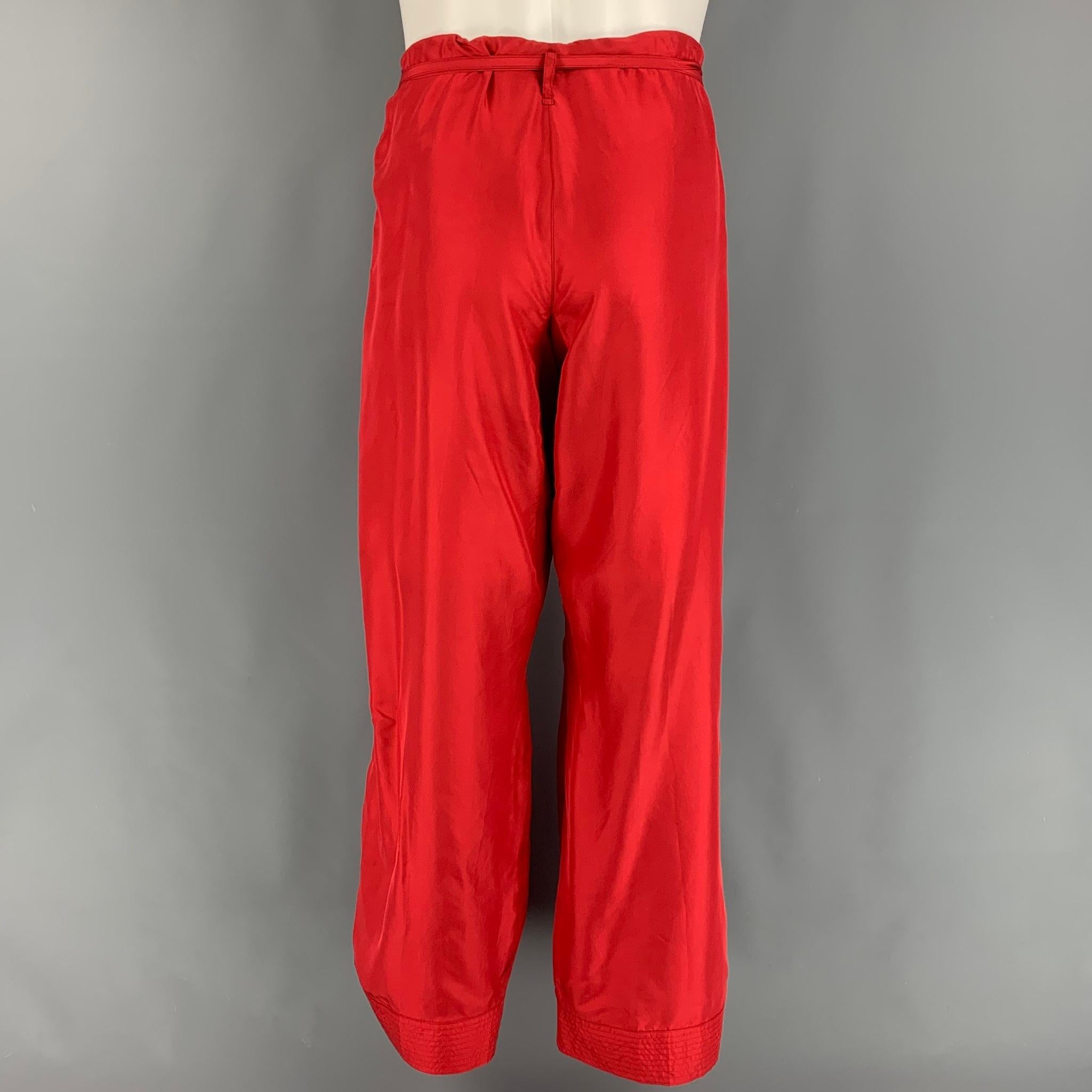GUCCI by TOM FORD Spring Summer 2001 collection karate style plants comes in a red silk featuring a wide leg style, drawstring waistband, quilted hem, and a button fly closure. Made in Italy. 

Very Good Pre-Owned Condition.
Marked:
