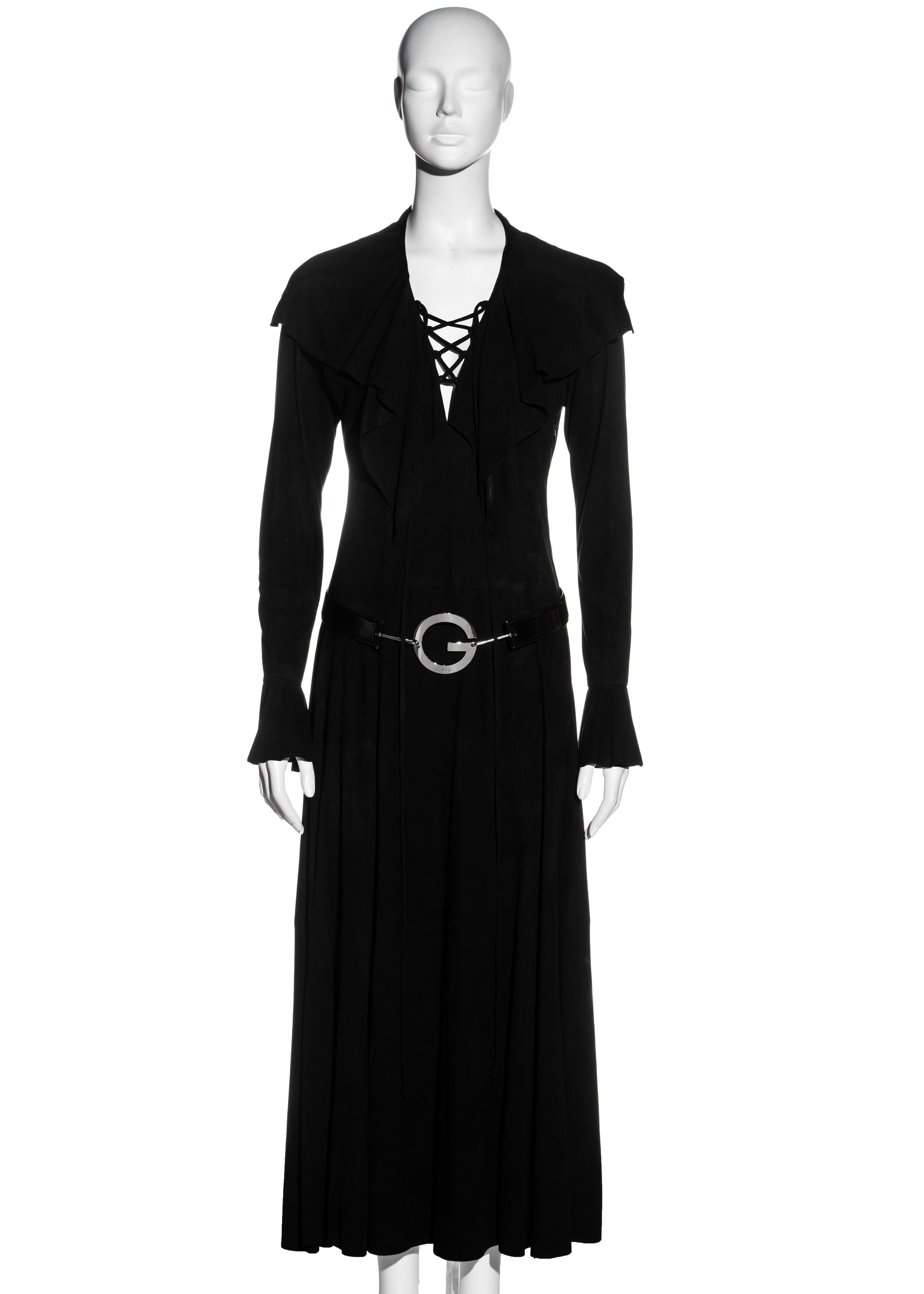 ▪ Gucci suede lace-up maxi dress and belt 
▪ Designed by Tom Ford 
▪ Deep v-neck with leather lace up fastening 
▪ Large cape collar with natural edge 
▪ Bishop sleeves with ruffled cuffs 
▪ Gold 'GG' etched buttons 
▪ Patent leather hip belt with