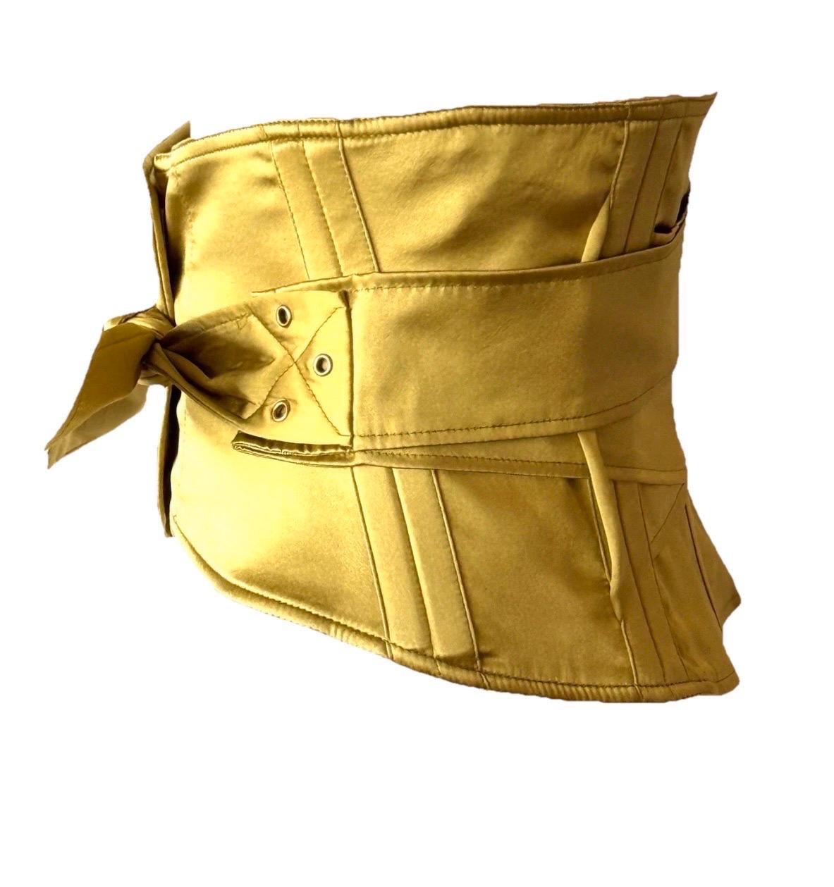 A sculptural corset belt from Tom Ford’s iconic Fall/Winter 2003 collection for Gucci. Crafted in rich yellow-gold stretch silk satin, this waist-defining piece is designed to cinch with a sleek, bodycon fit. Seen styled on the runway layered over