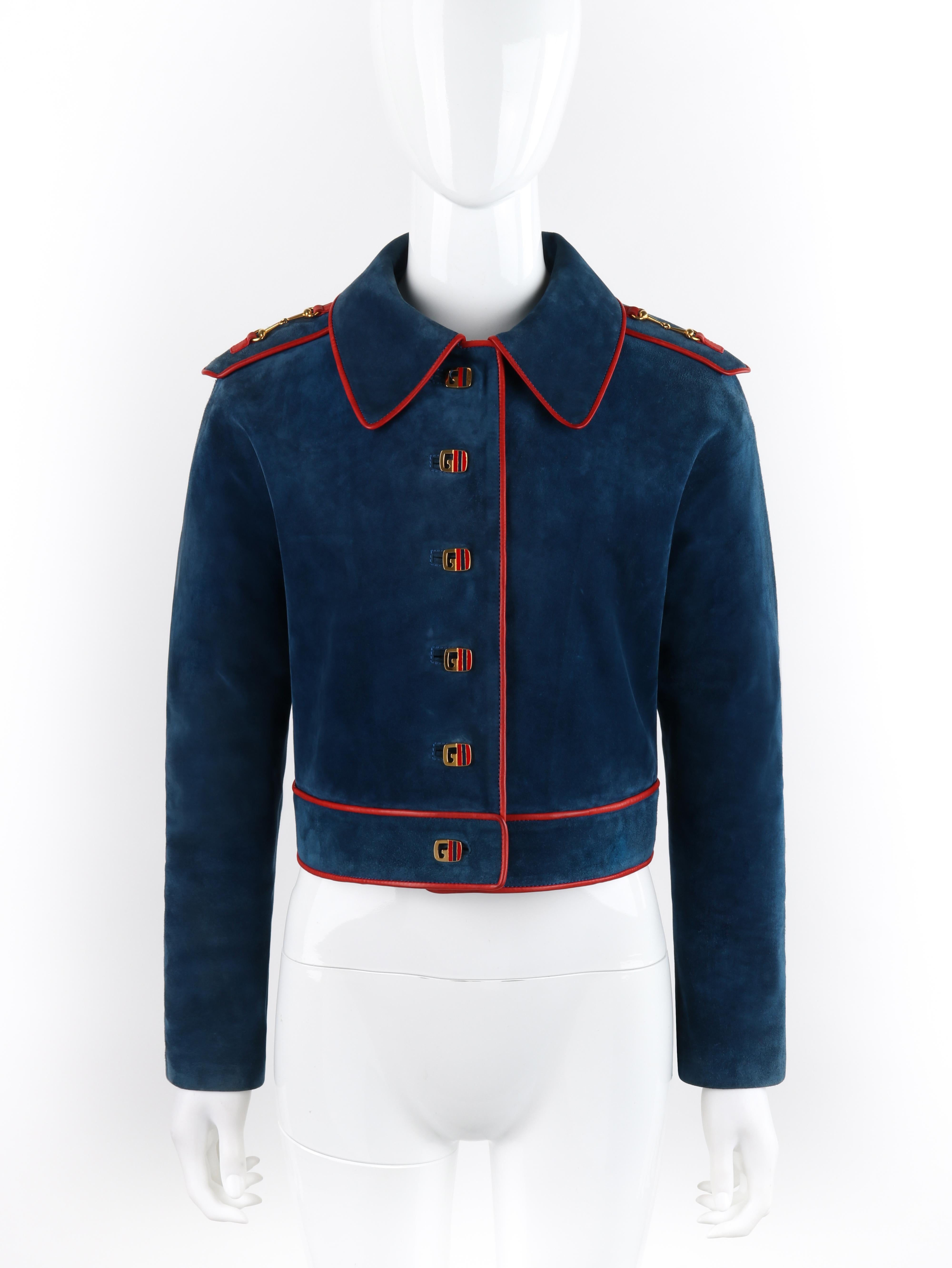 Brand / Manufacturer: Gucci
Circa: 1970s
Style: Cropped Jacket
Color(s): Shades of blue, red, gold
Lined: Yes 
Unmarked Fabric Content (feel of): Suede (primary fabric), leather (trim), silk (lining), metal (hardware)
Additional Details /
