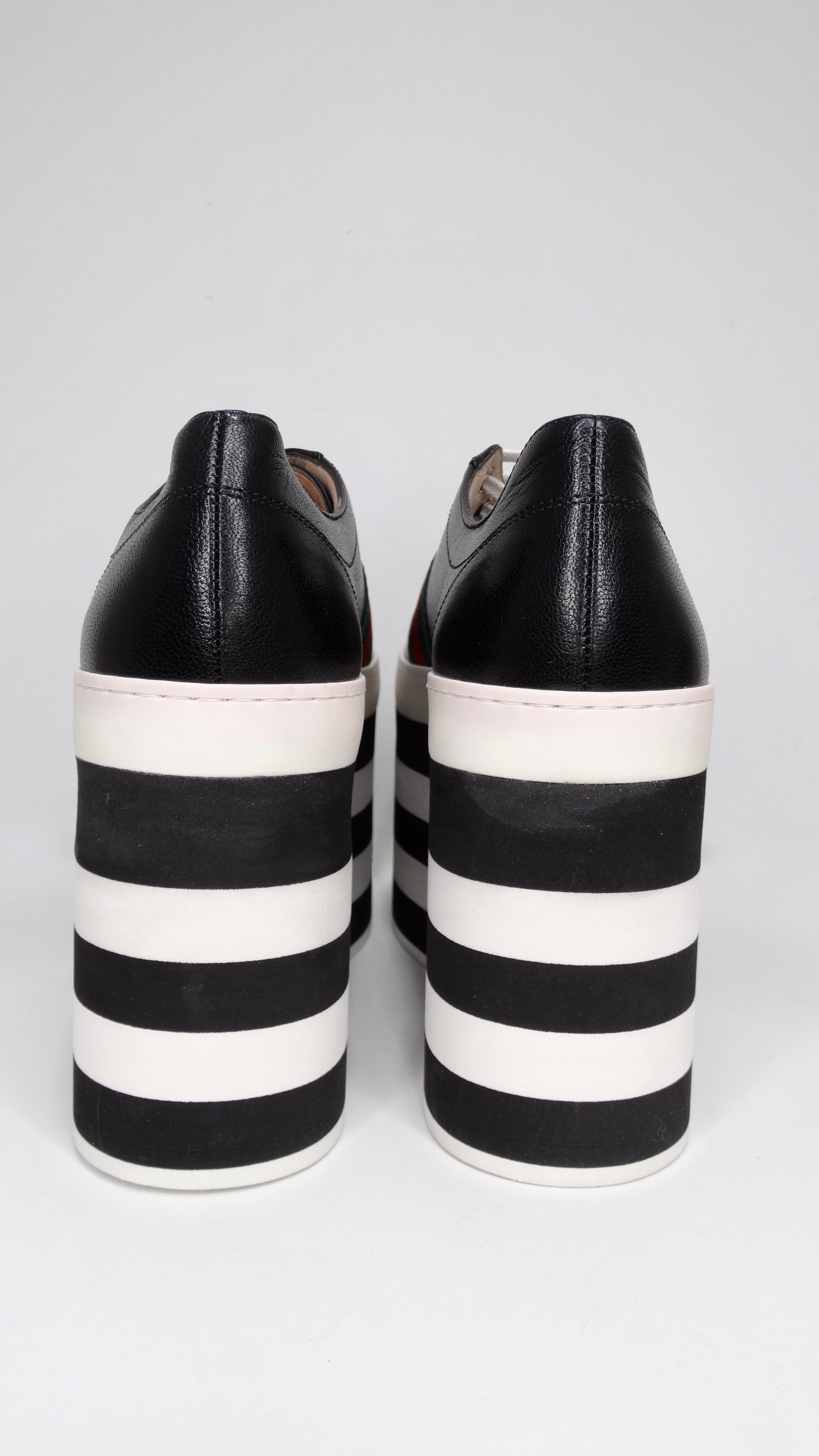 Make a statement with these funky sneakers! These shoes feature calf leather, rounded roes, and a black and white striped 4.5 inch platform with the iconic red and green Gucci colors accenting the shoe. Slight scuffing on platform as shown in