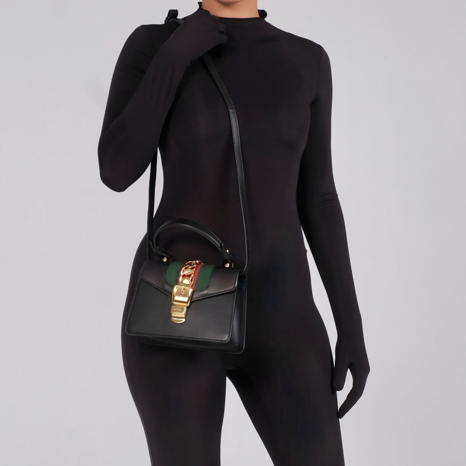 Color: Black with web details
Material: Leather
Model No. 4700270
Comes with: Leather shoulder strap, multicolor rope shoulder strap & dust bag
Condition: Excellent. Bag is like new.
Made in Italy

Measurements~
Height 5.5”
Width 3.25”
Depth 3”
Drop
