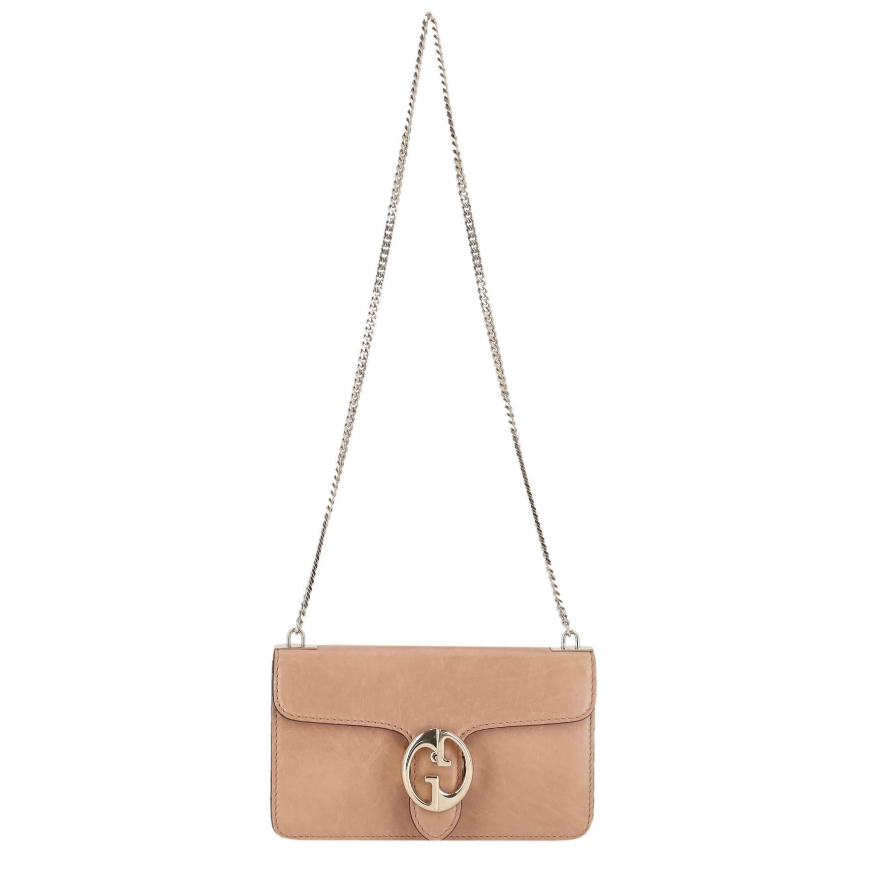Sac à bandoulière moyen en cuir de veau Gucci avec chaîne GG entrelacée

Sac beige en cuir de veau lisse, orné de l'emblème GG emboîté en or clair.

Bandoulière en maillons de chaîne et rabat sur le devant menant à un intérieur en cuir avec une