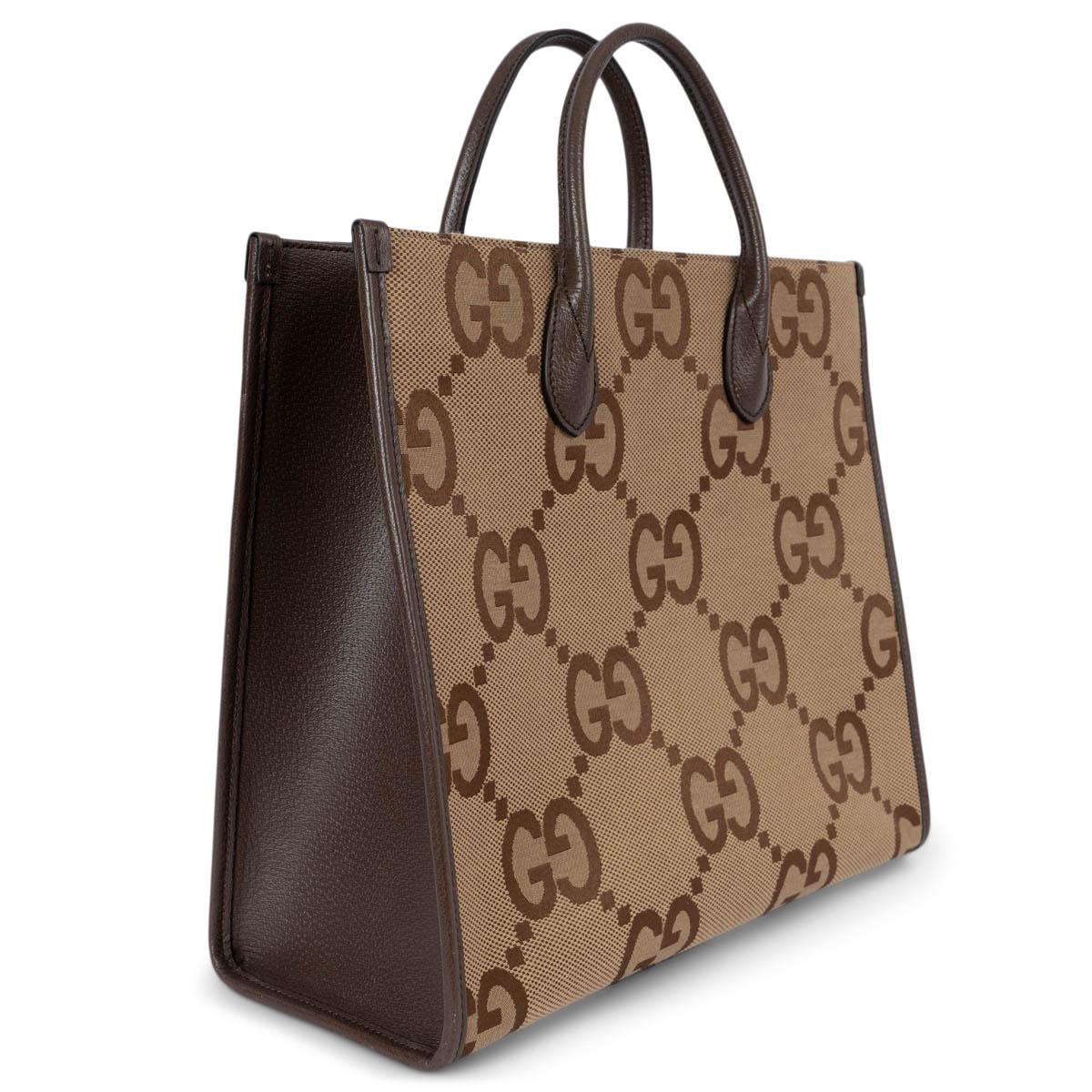 100% authentic Gucci tote in camel and ebony Jumbo GG canvas with dark brown leather trims and gussets. Features an adjustable and detachable green-red web strap. Closes with a dog-hook on top and is lined in canvas with a zipper pocket against the